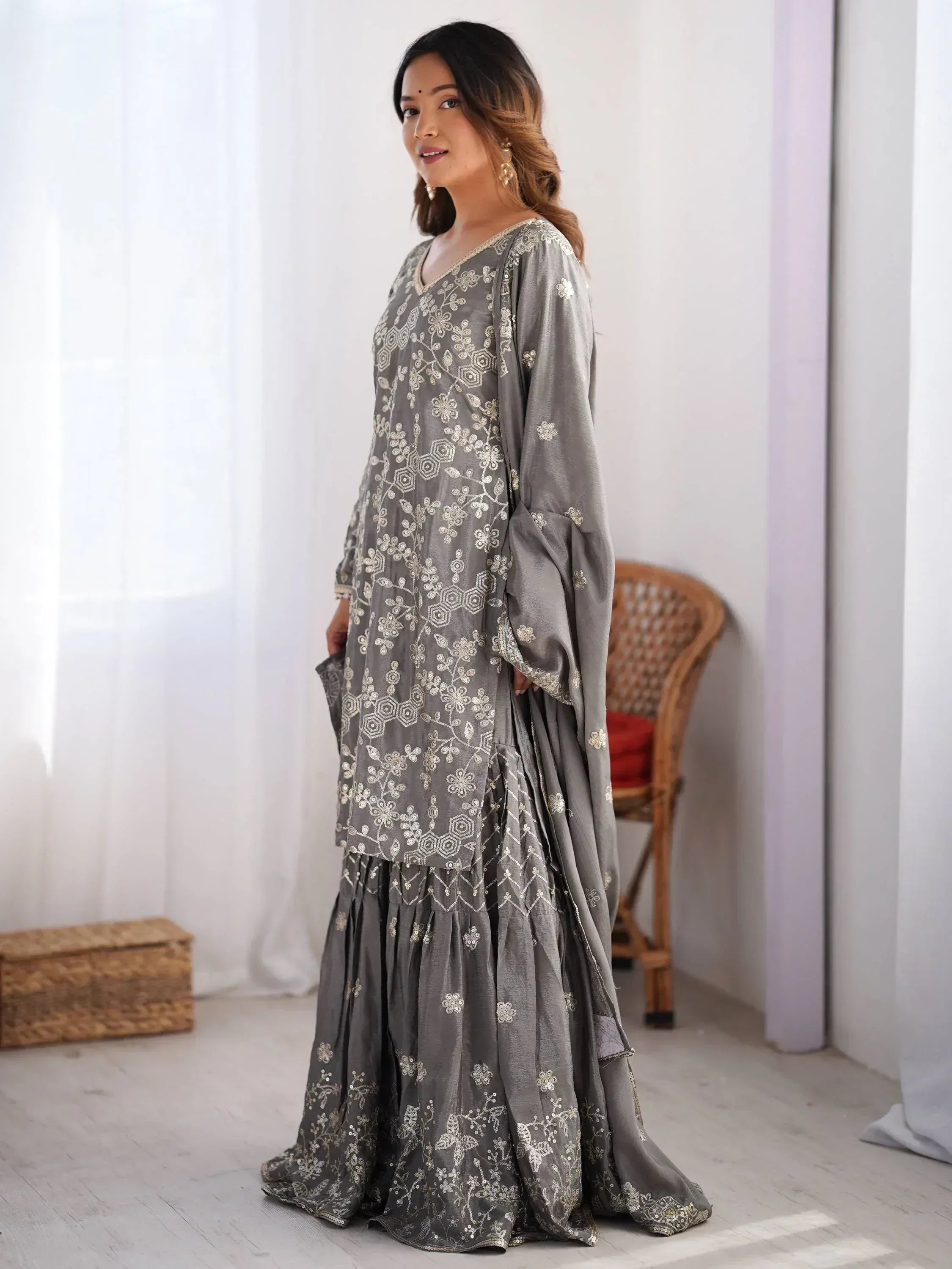 Grey embroidered ethnic gown with floral motifs, perfect for Indian occasions and festive wear.