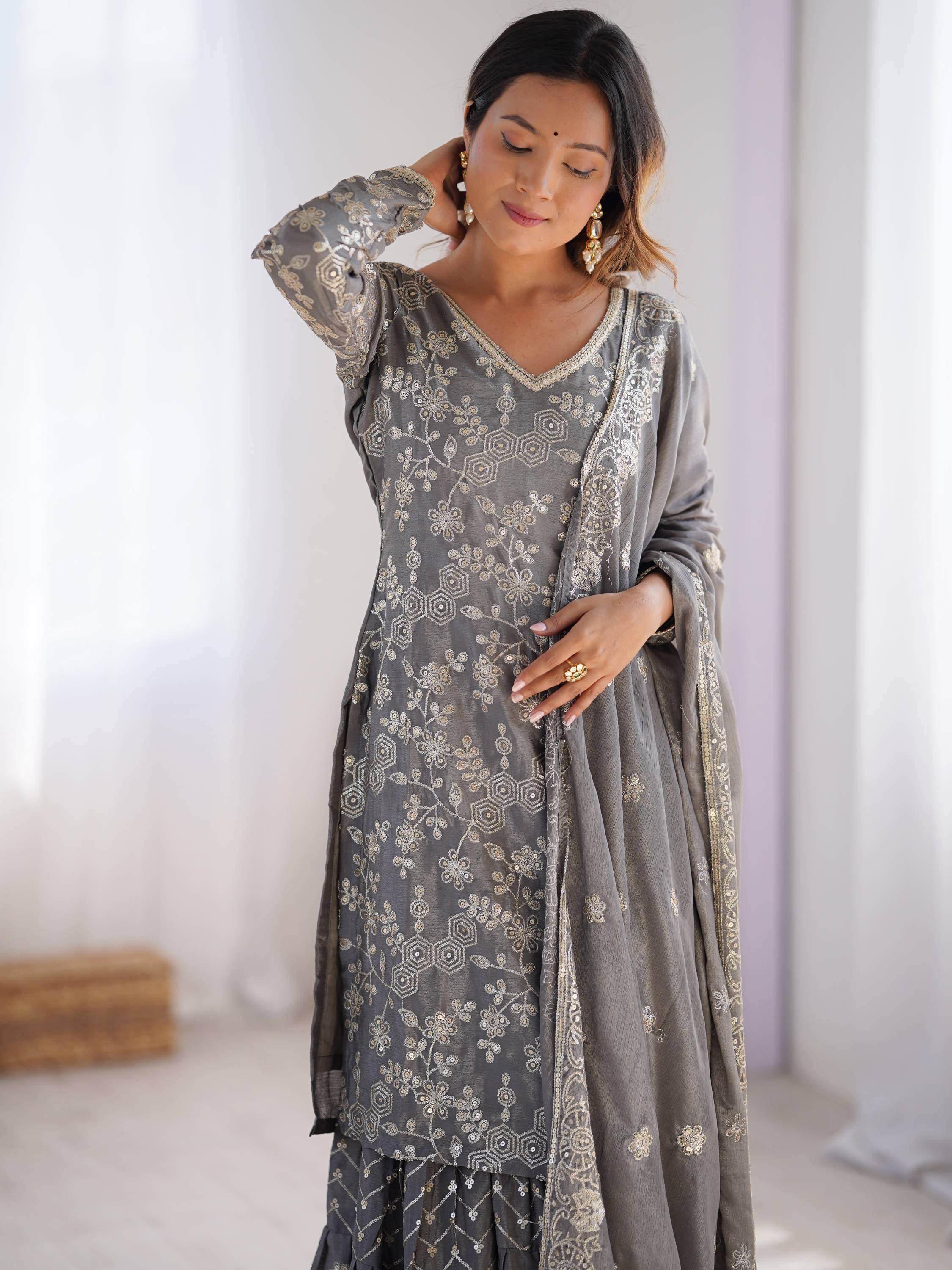 Grey embroidered salwar kameez with gold floral detailing, perfect for Indian ethnic wear occasions.