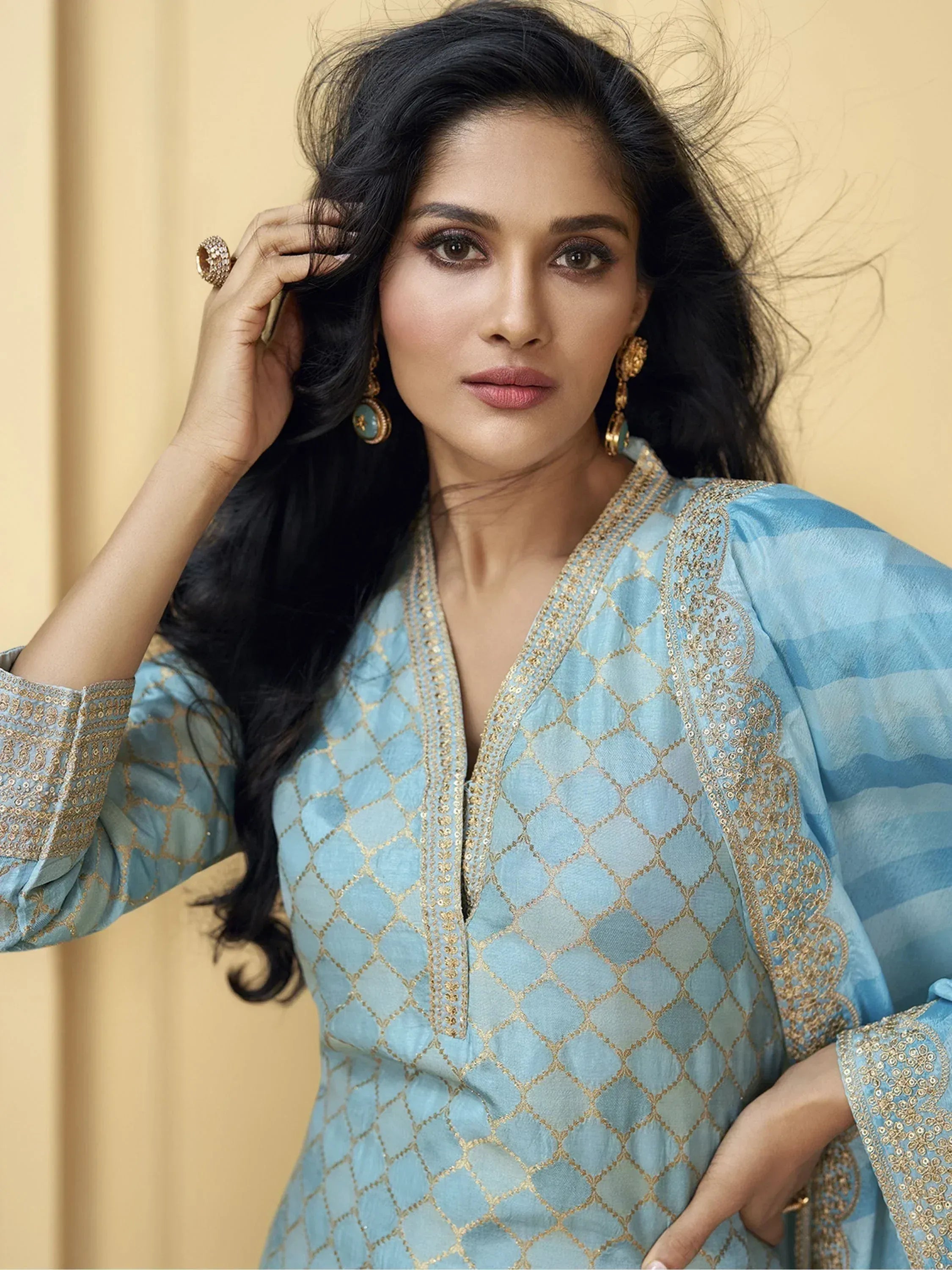 Woman in light blue ethnic gown with gold embroidery, perfect for Indian occasions and festive wear.