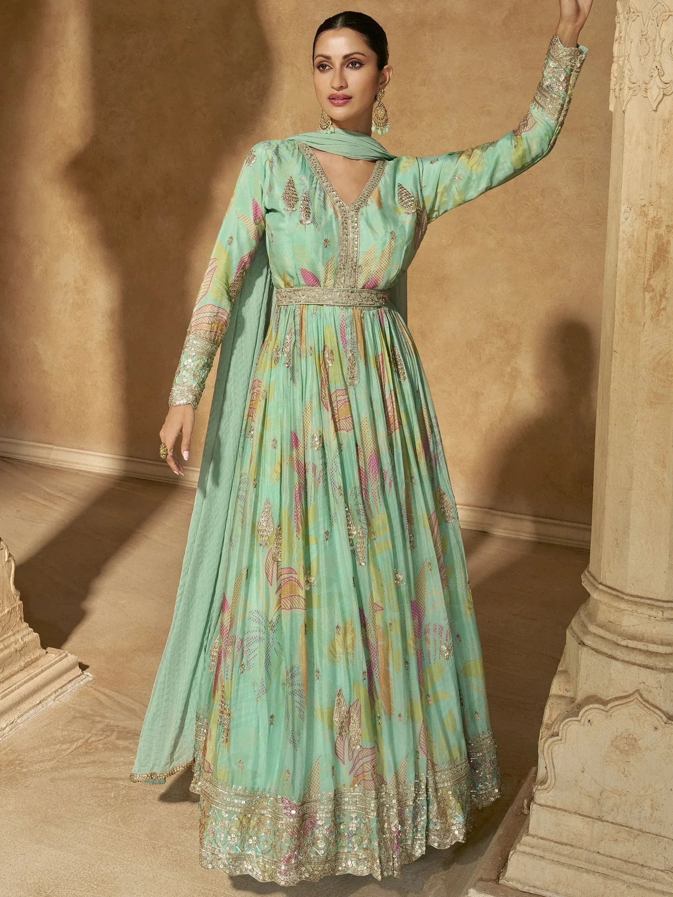 Mint green anarkali gown with floral print and gold embroidery, perfect for Indian ethnic wear occasions.