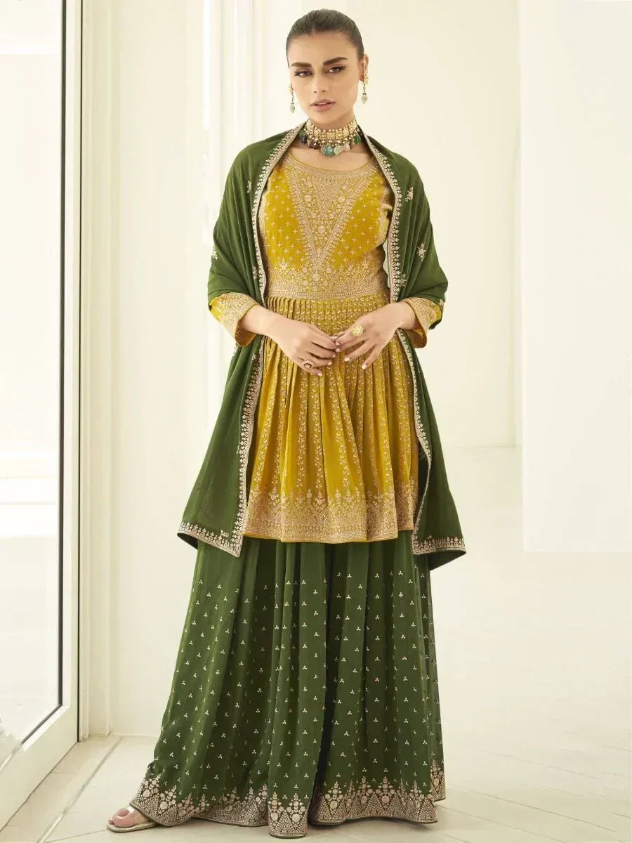 Woman wearing green and yellow designer ethnic lehenga with dupatta and traditional jewelry