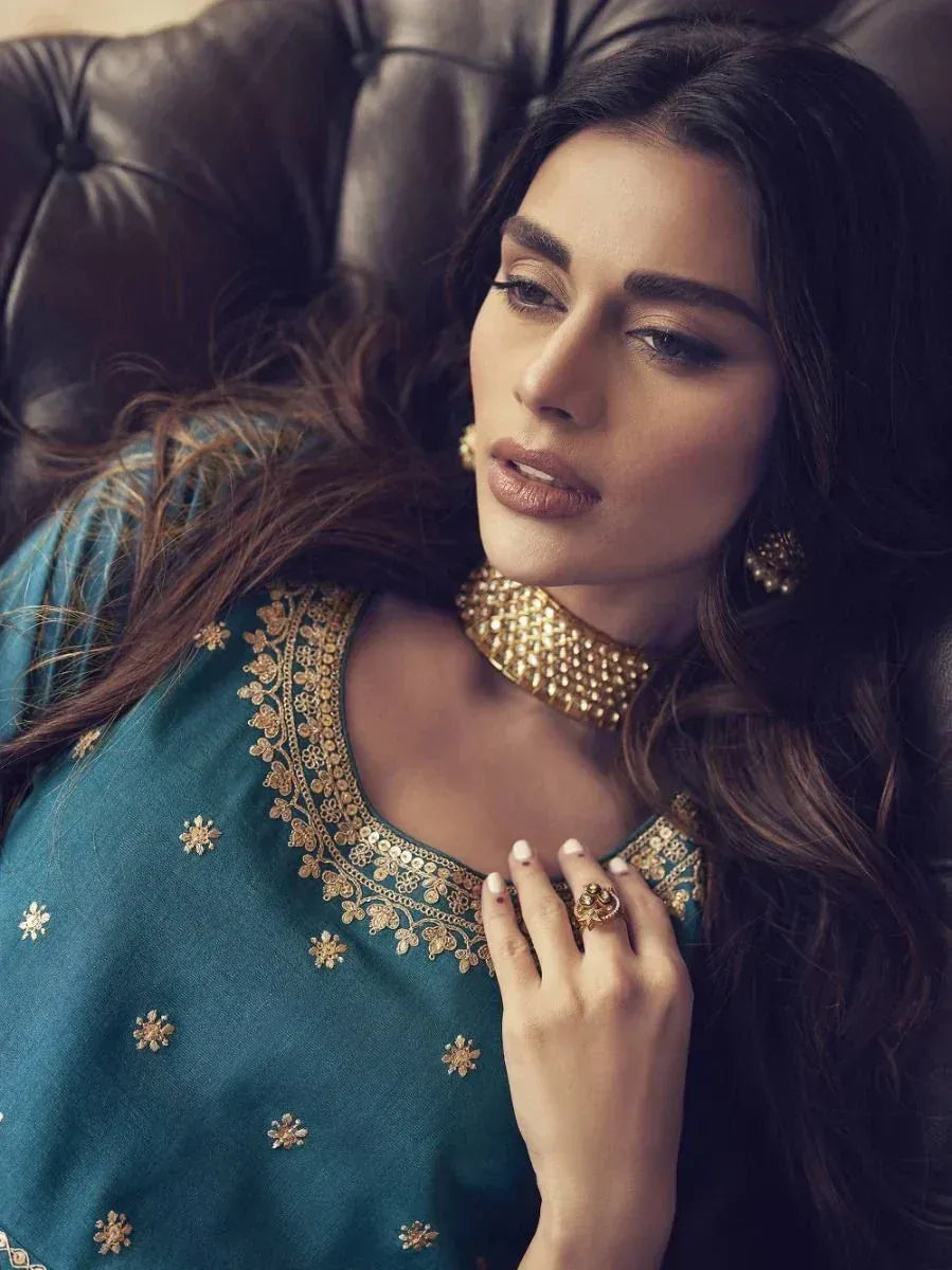 Teal embroidered ethnic kurti with gold jewelry, perfect for Indian festive wear