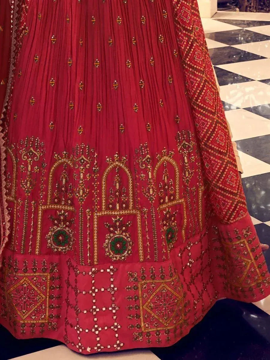 Red embroidered lehenga with gold and green detailing, ethnic Indian wear