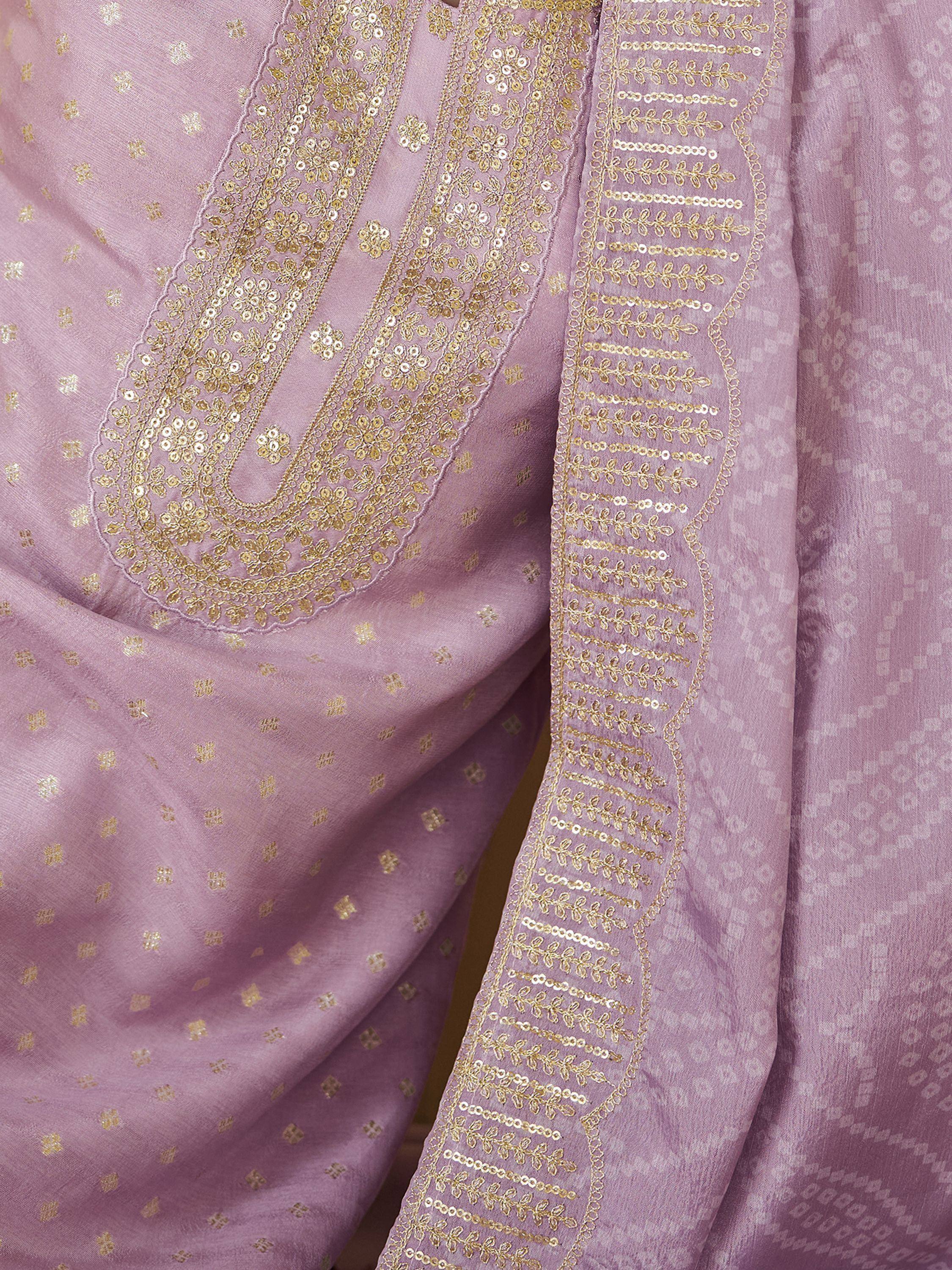 Lavender ethnic wear with gold sequin embroidery and floral patterns, perfect for festive occasions.