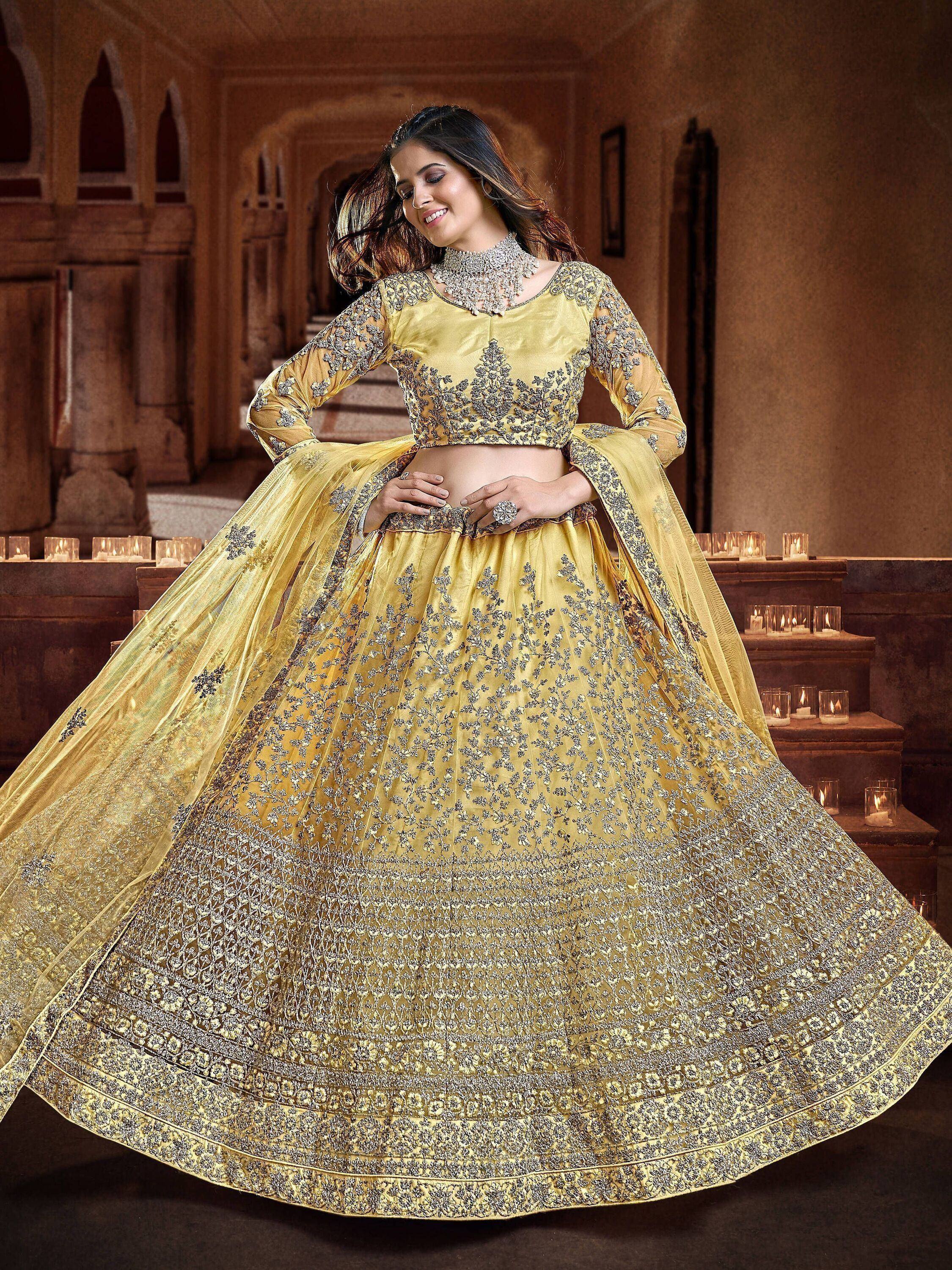 Elegant yellow designer lehenga choli with intricate silver embroidery, perfect for Indian weddings and festive occasions.