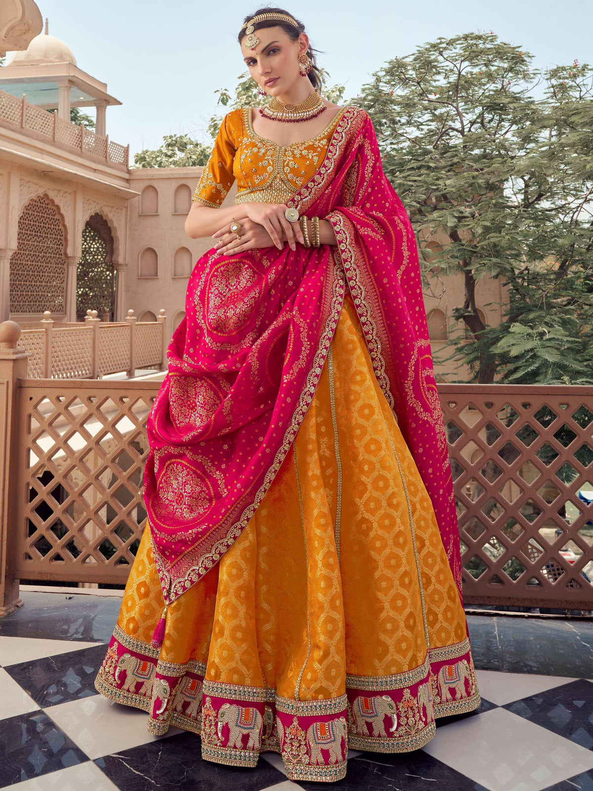 Yellow and pink embroidered lehenga choli with elephant motifs, perfect for Indian weddings and festive occasions.