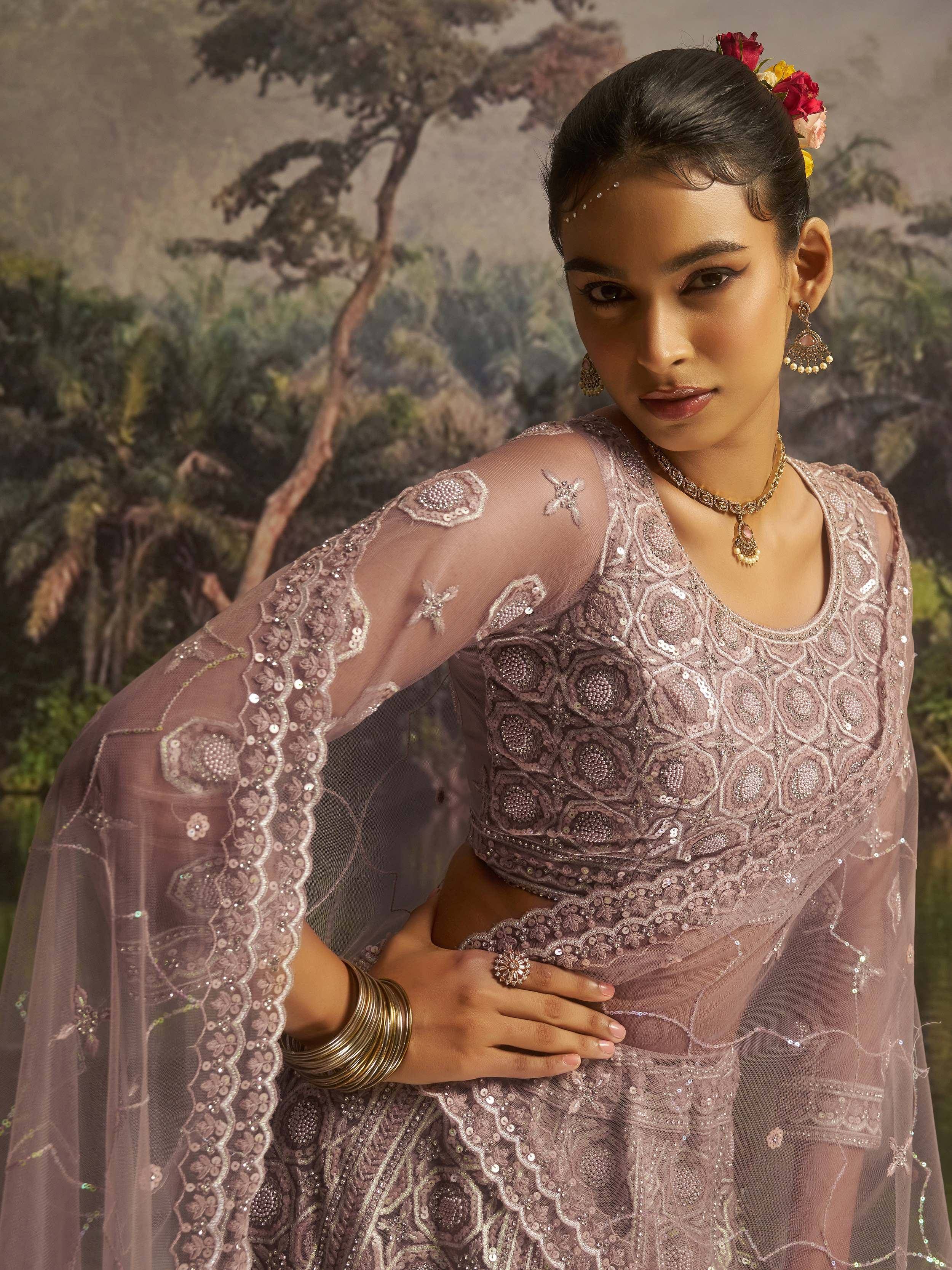 Elegant mauve designer lehenga choli with intricate sequin embroidery and sheer cape, perfect for Indian ethnic wear.