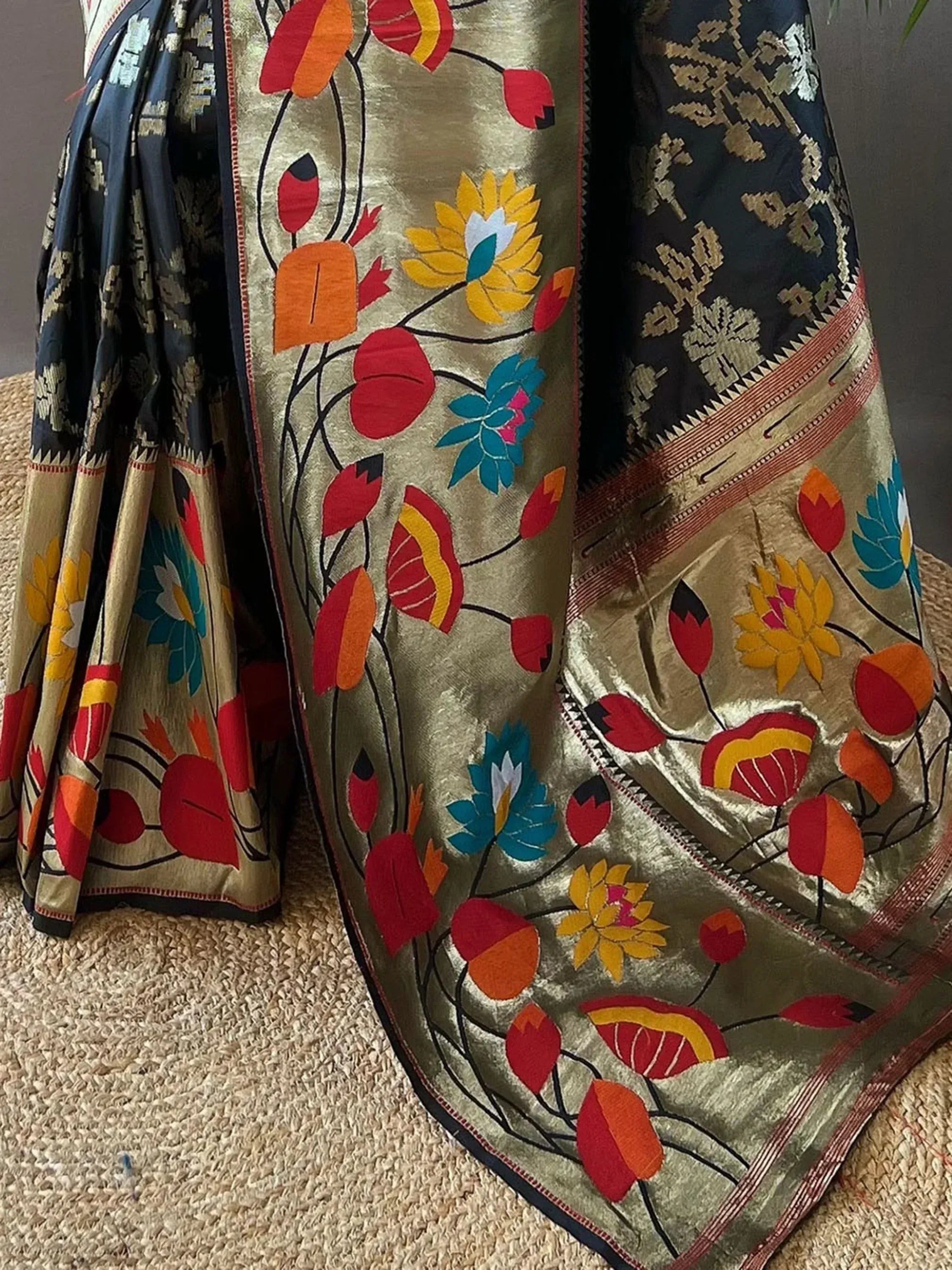Vibrant floral embroidered saree with gold and black border, perfect for ethnic occasions