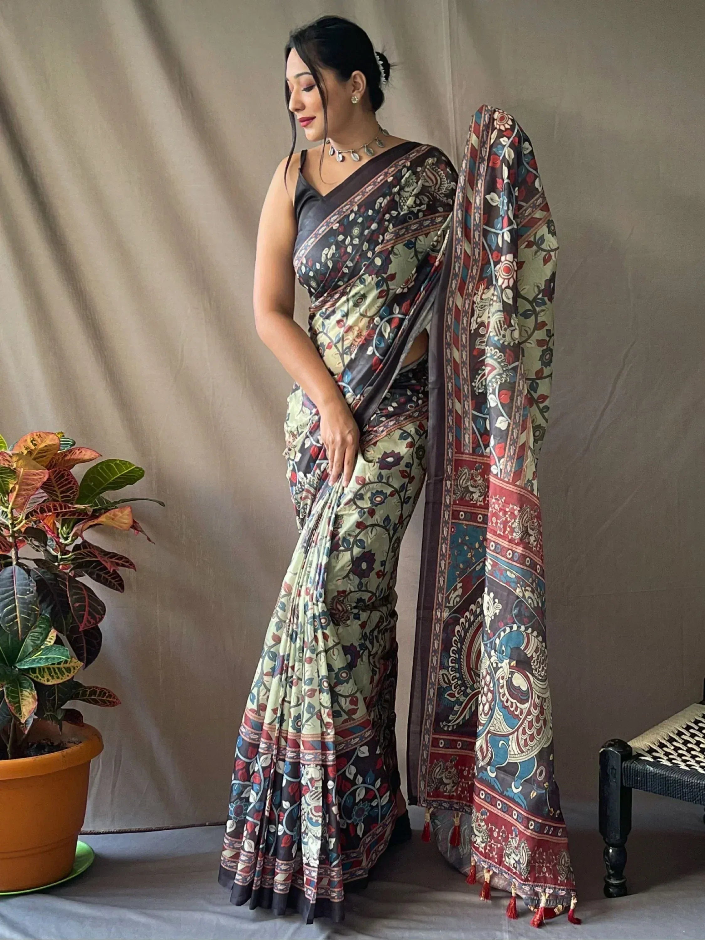 Woman in floral printed Indian saree with peacock border, ethnic wear for festive occasions