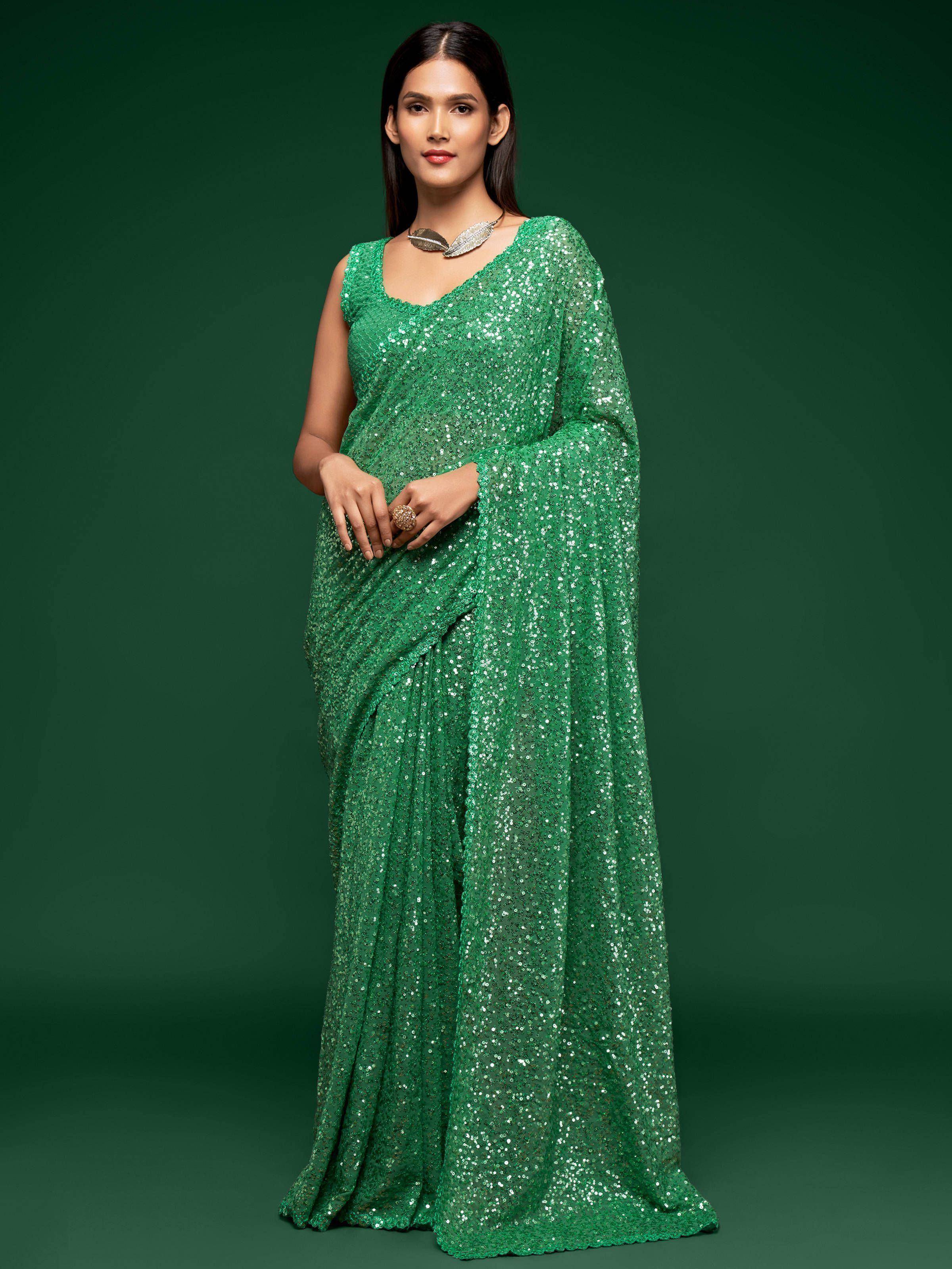 Emerald green sequin saree with sleeveless blouse, perfect for Indian ethnic wear events