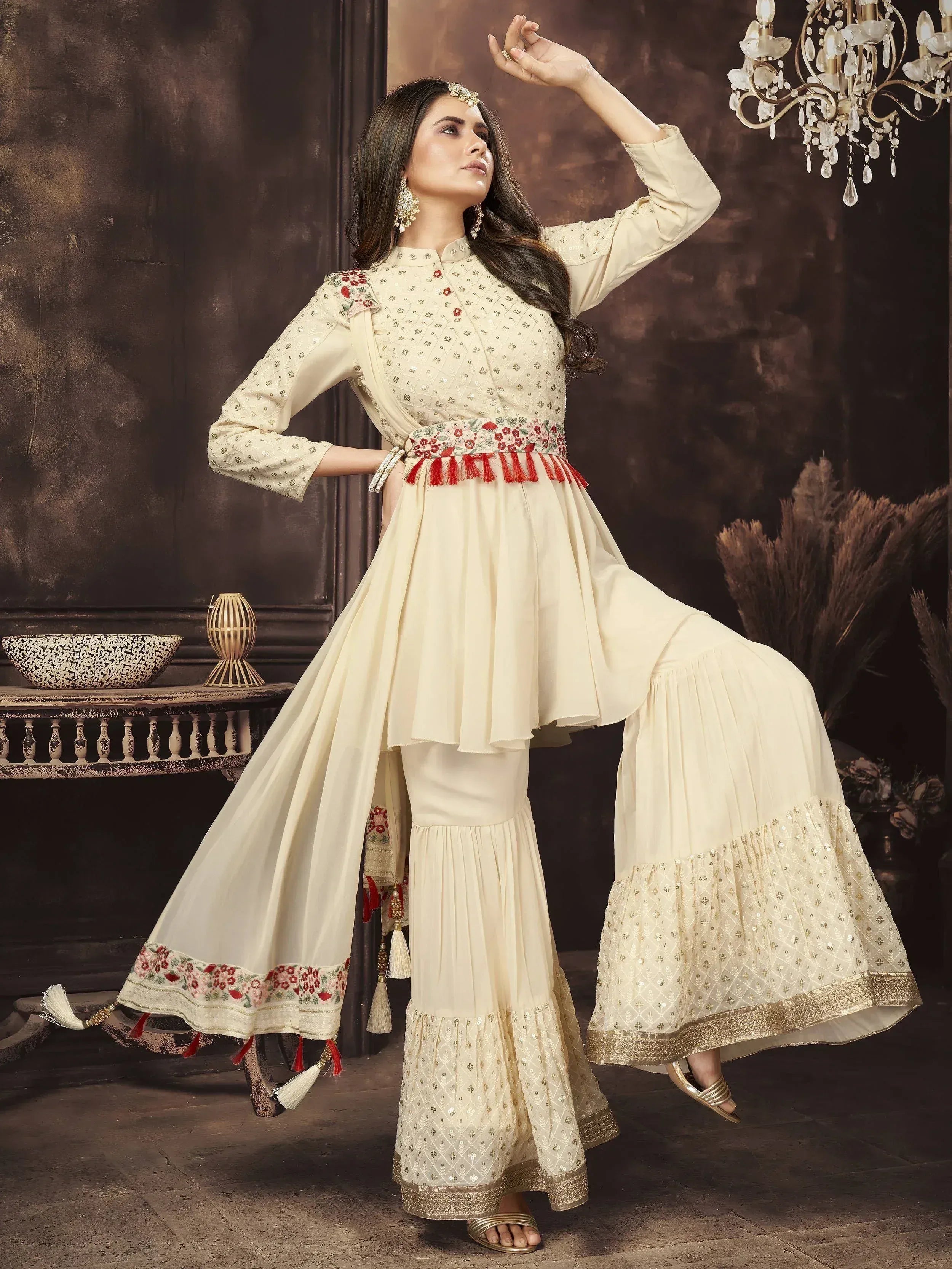Woman in cream embroidered designer sharara suit with floral details and dupatta, Indian ethnic wear