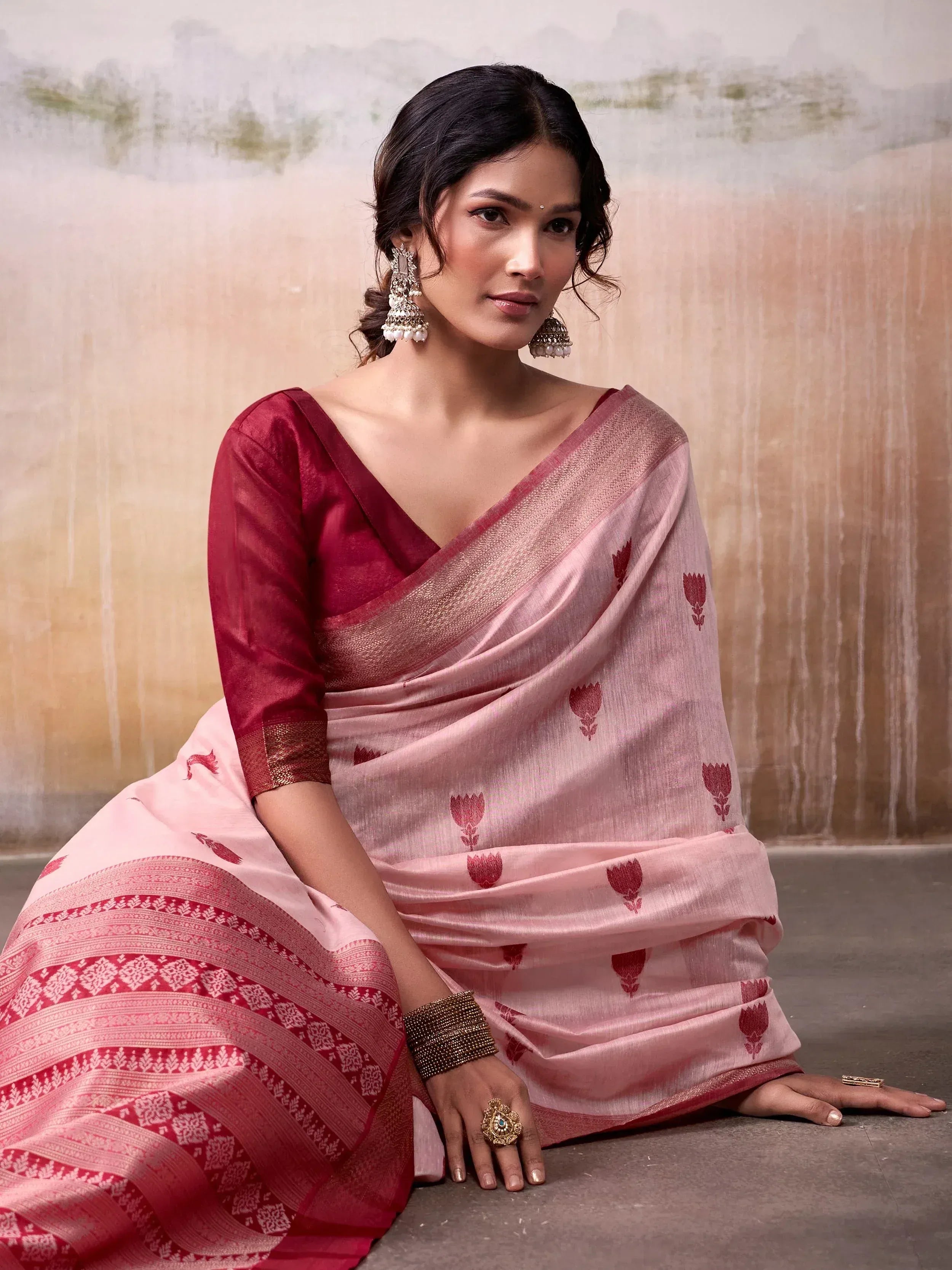Elegant pink and maroon saree with floral motifs and traditional jewelry, perfect for Indian ethnic wear