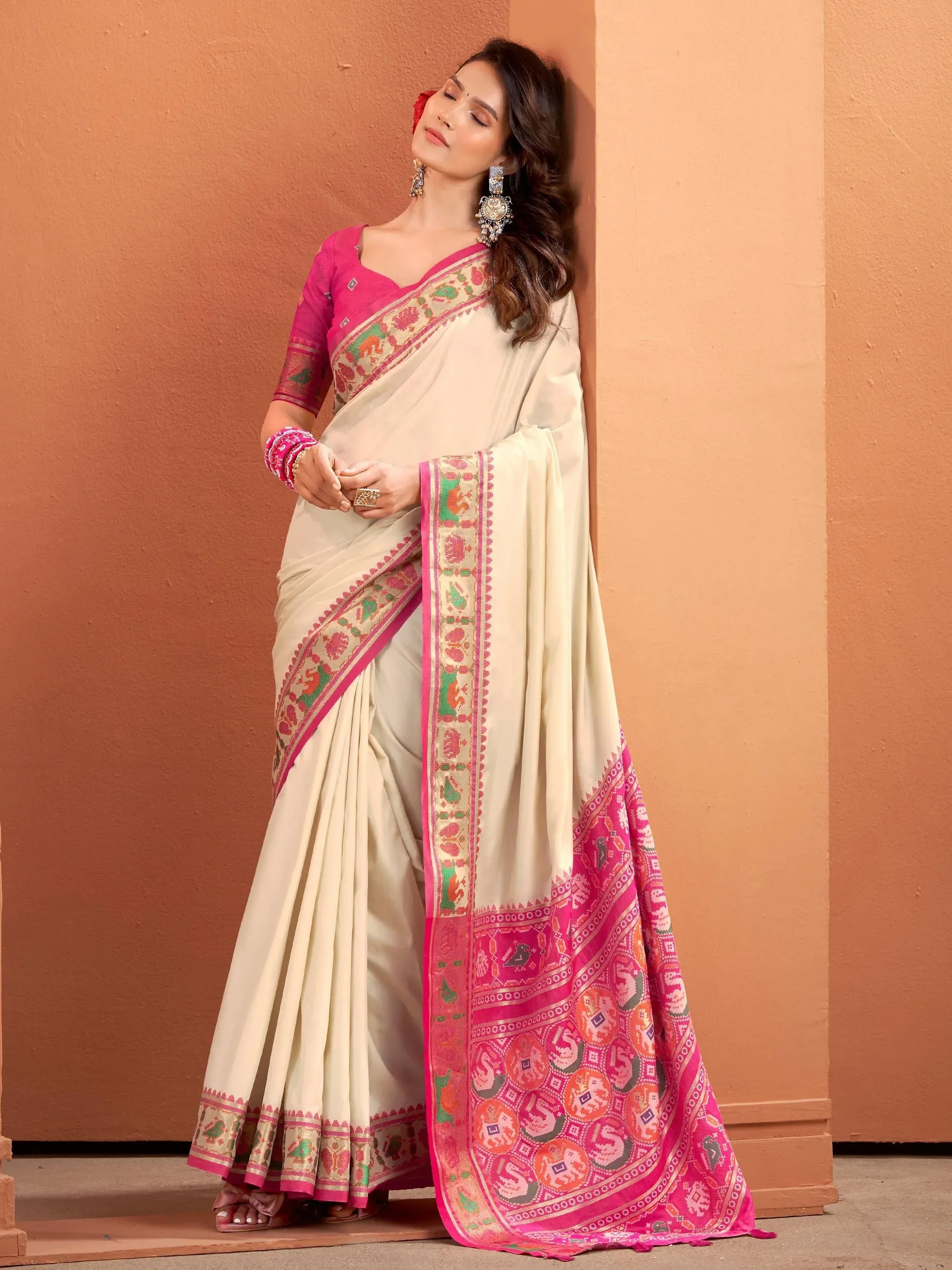 Elegant cream saree with pink border and intricate embroidery, paired with matching blouse for Indian ethnic wear.