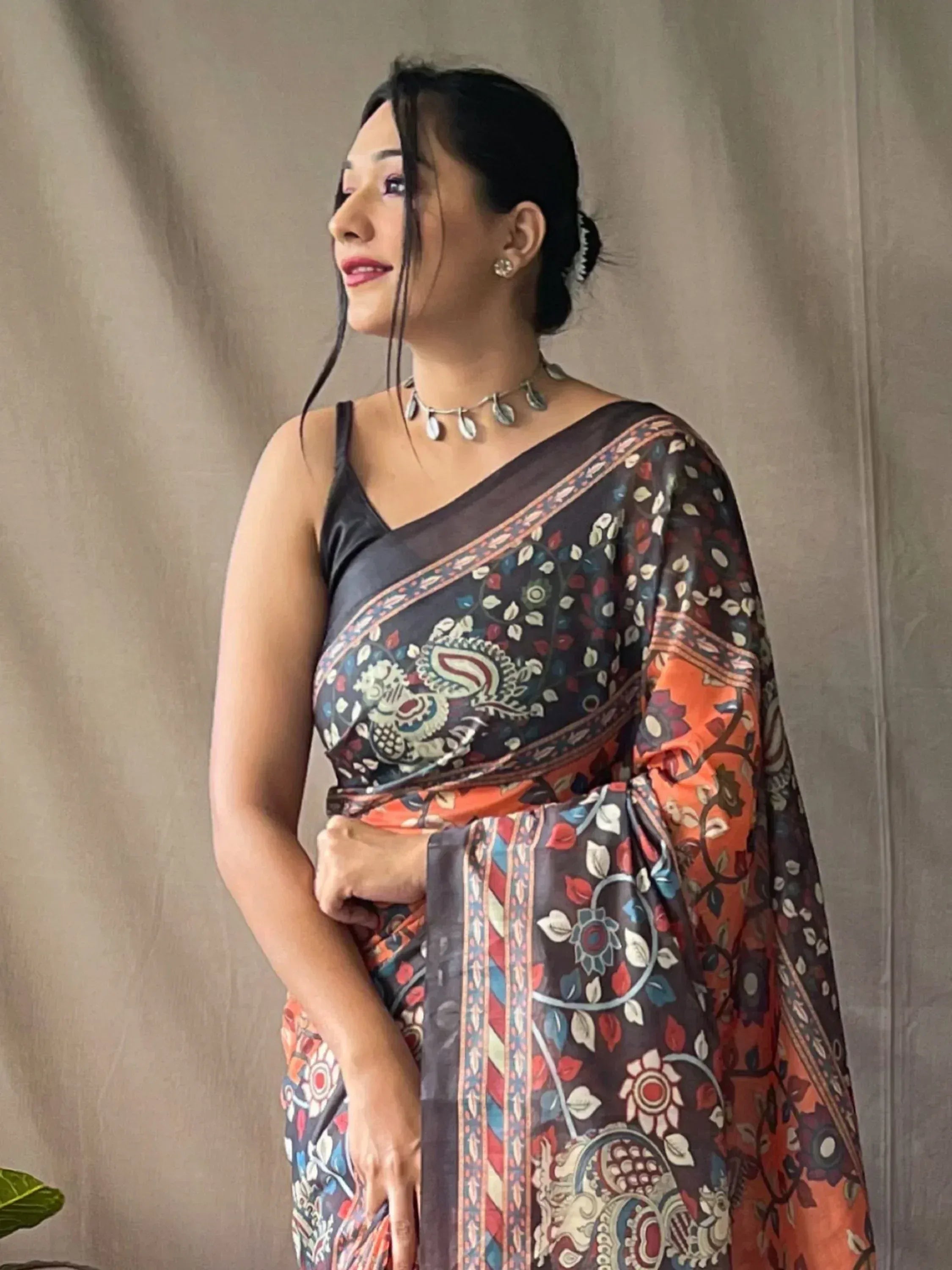 Woman in printed ethnic saree with floral paisley design, perfect for Indian occasions