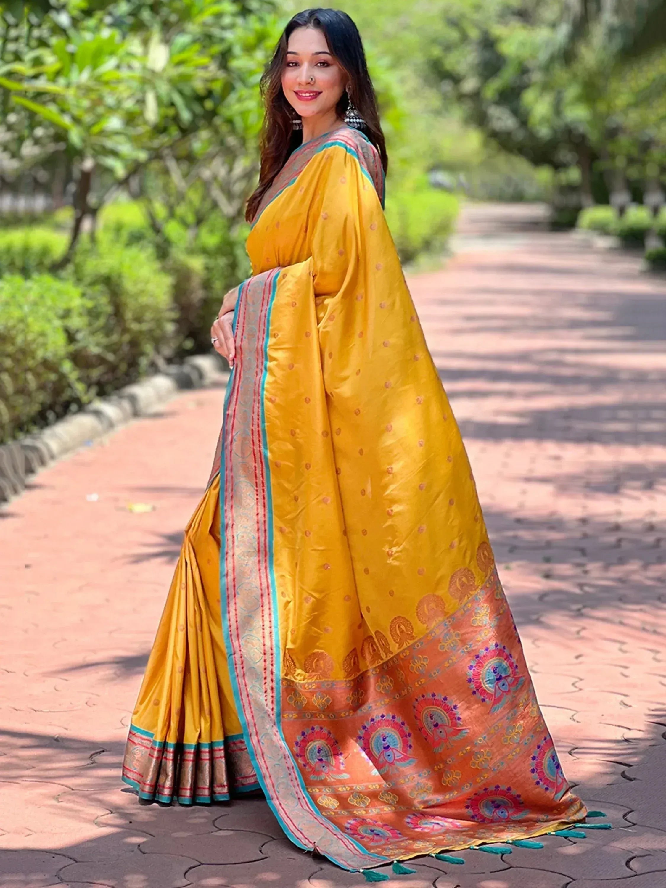 Yellow silk saree with peacock motifs and embroidered border, perfect for Indian ethnic wear occasions