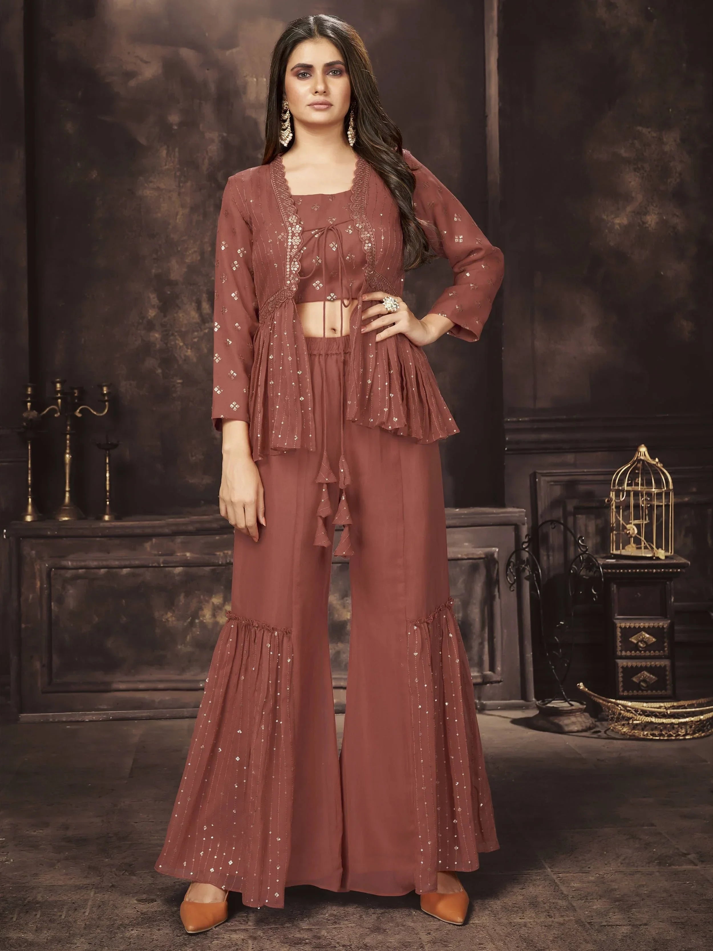 Woman in a brown embellished ethnic co-ord set with flared pants and long jacket