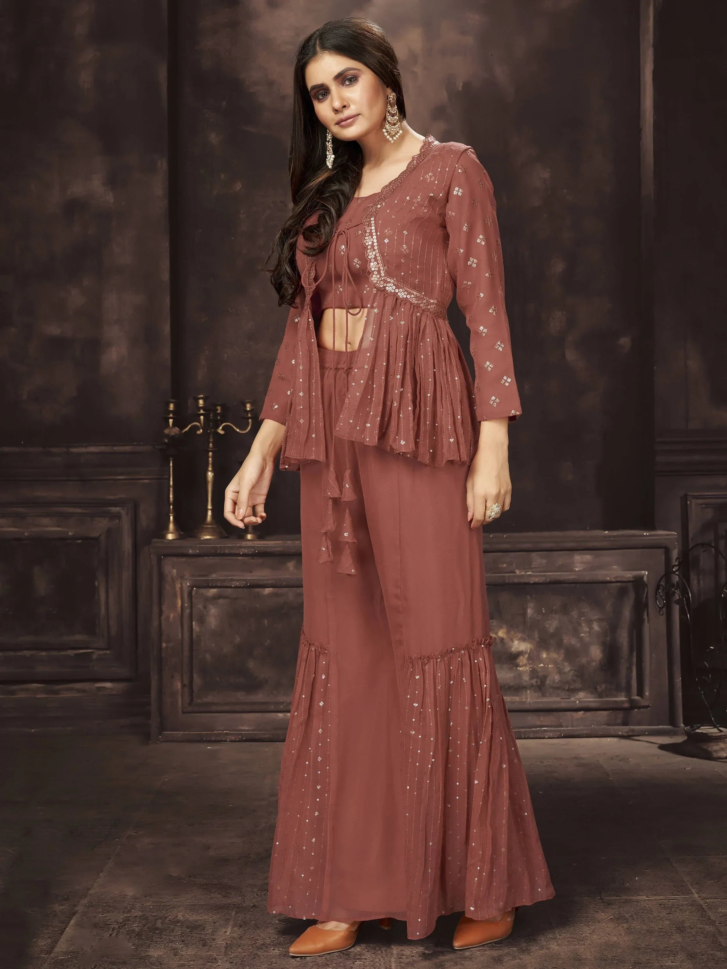 Woman wearing mauve embroidered ethnic palazzo set with sequin details and matching jacket