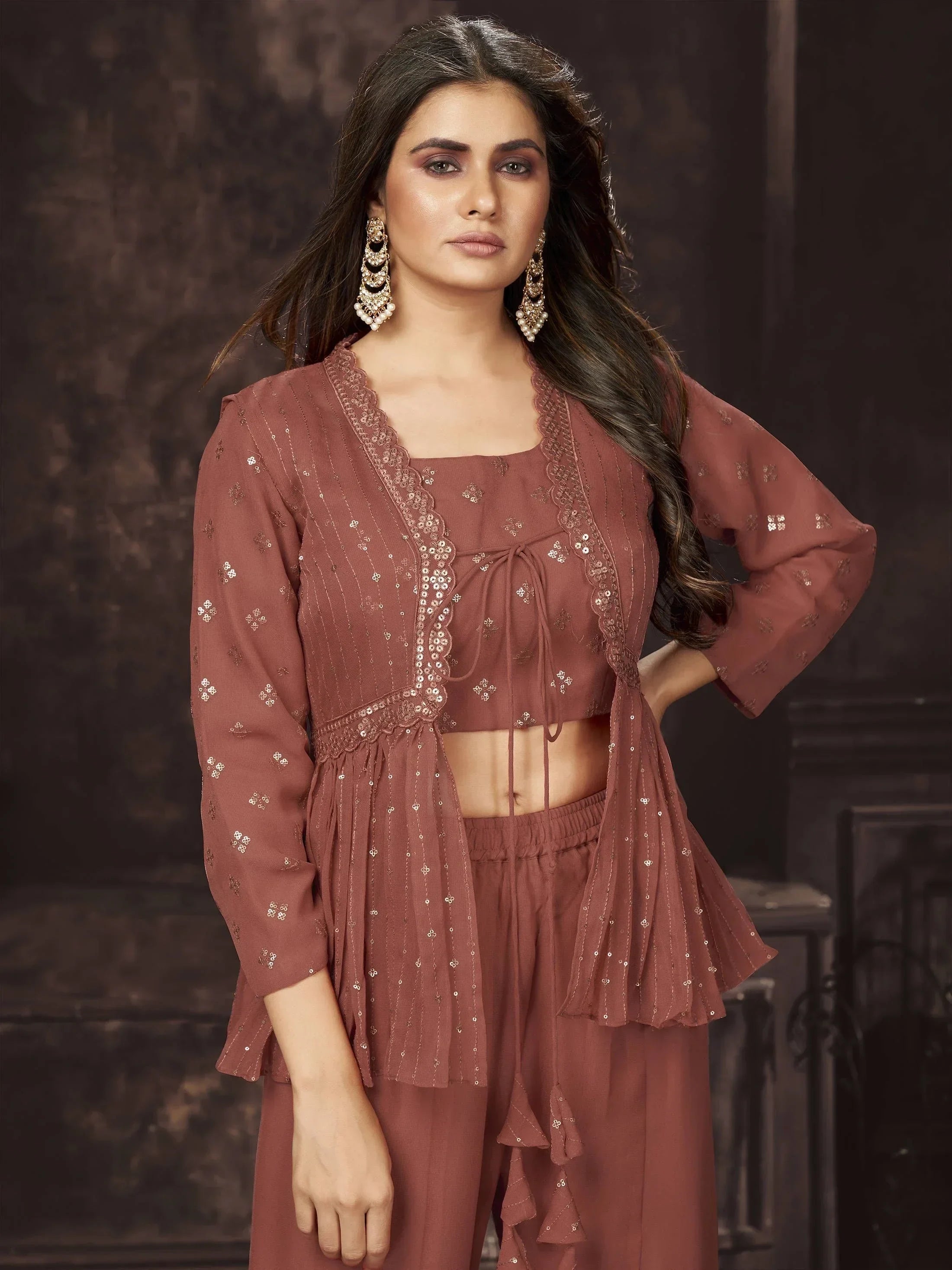 Woman wearing a brown embroidered ethnic crop top and palazzo set with statement earrings