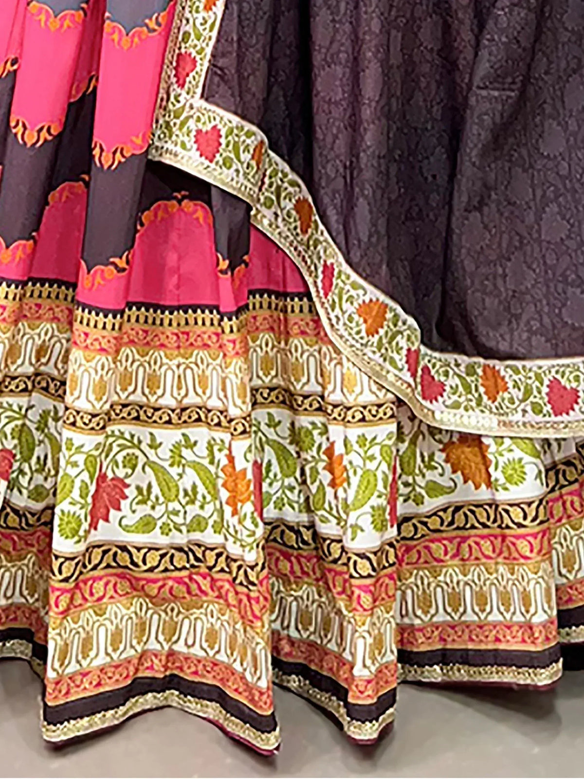 Black and pink printed lehenga choli with floral border and ethnic embroidery details