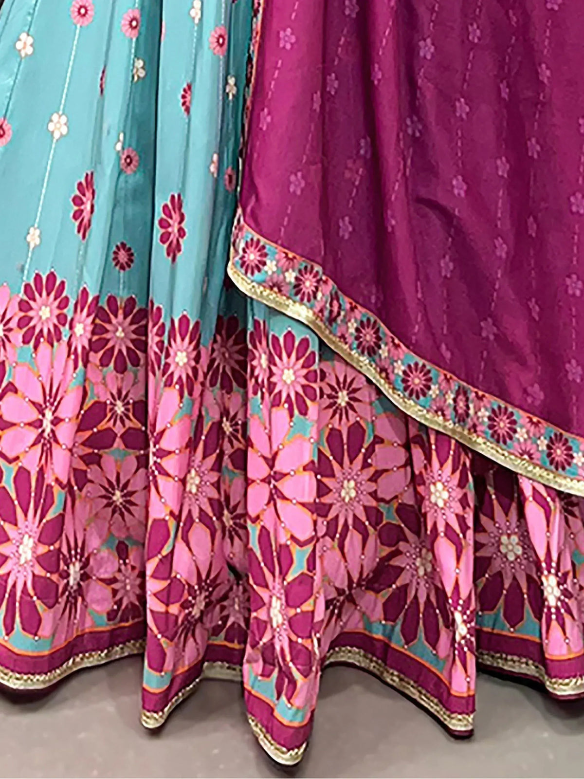 Turquoise and magenta floral lehenga choli with intricate embroidery and border detailing