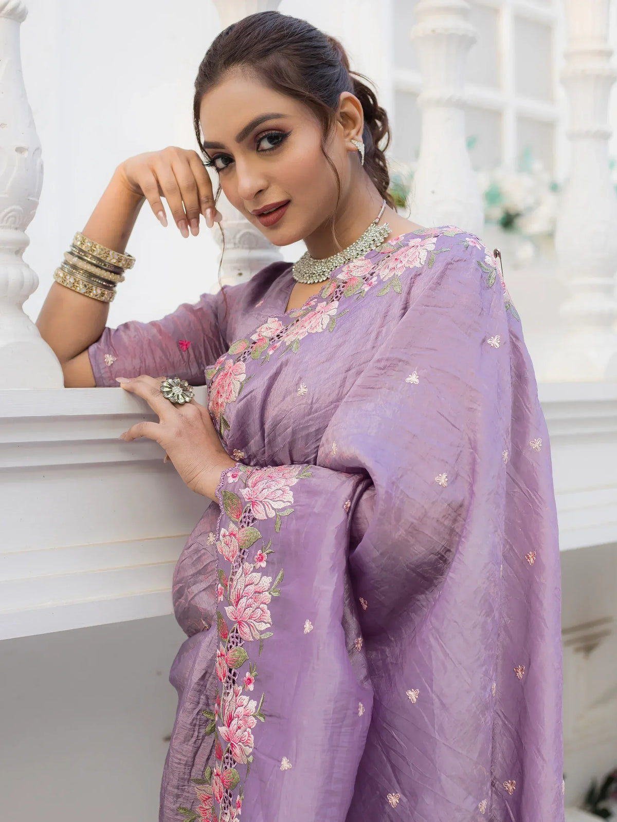Purple floral embroidered salwar kameez with traditional jewelry, perfect for Indian ethnic wear occasions