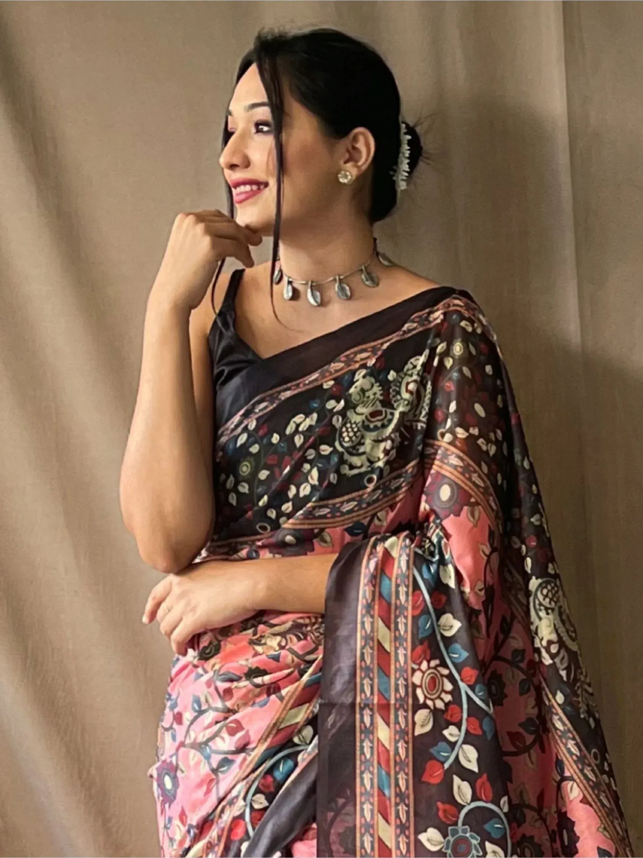 Woman in elegant floral print saree with black blouse, traditional Indian ethnic wear