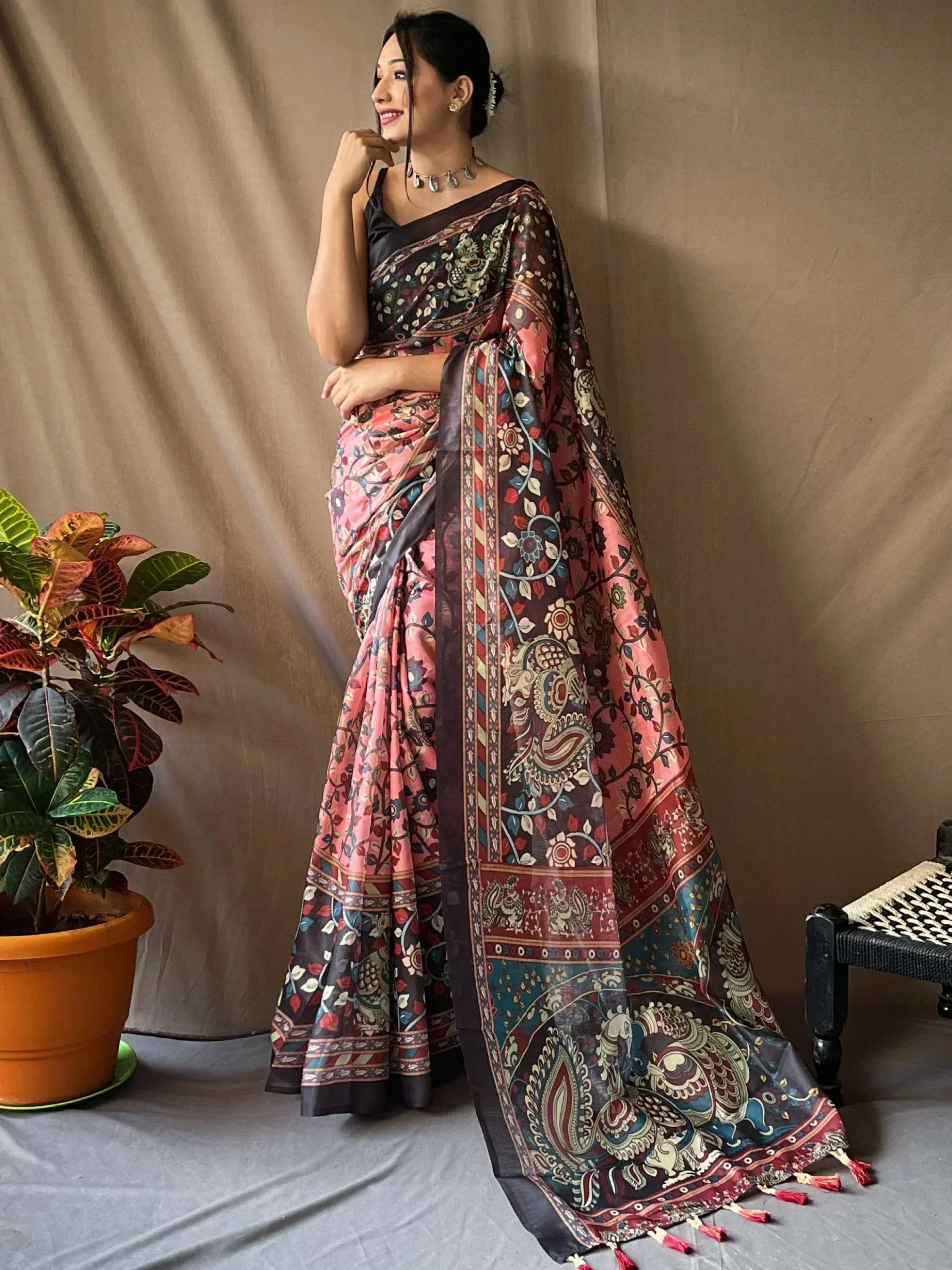 Woman in elegant pink and brown printed saree with paisley border, Indian ethnic wear