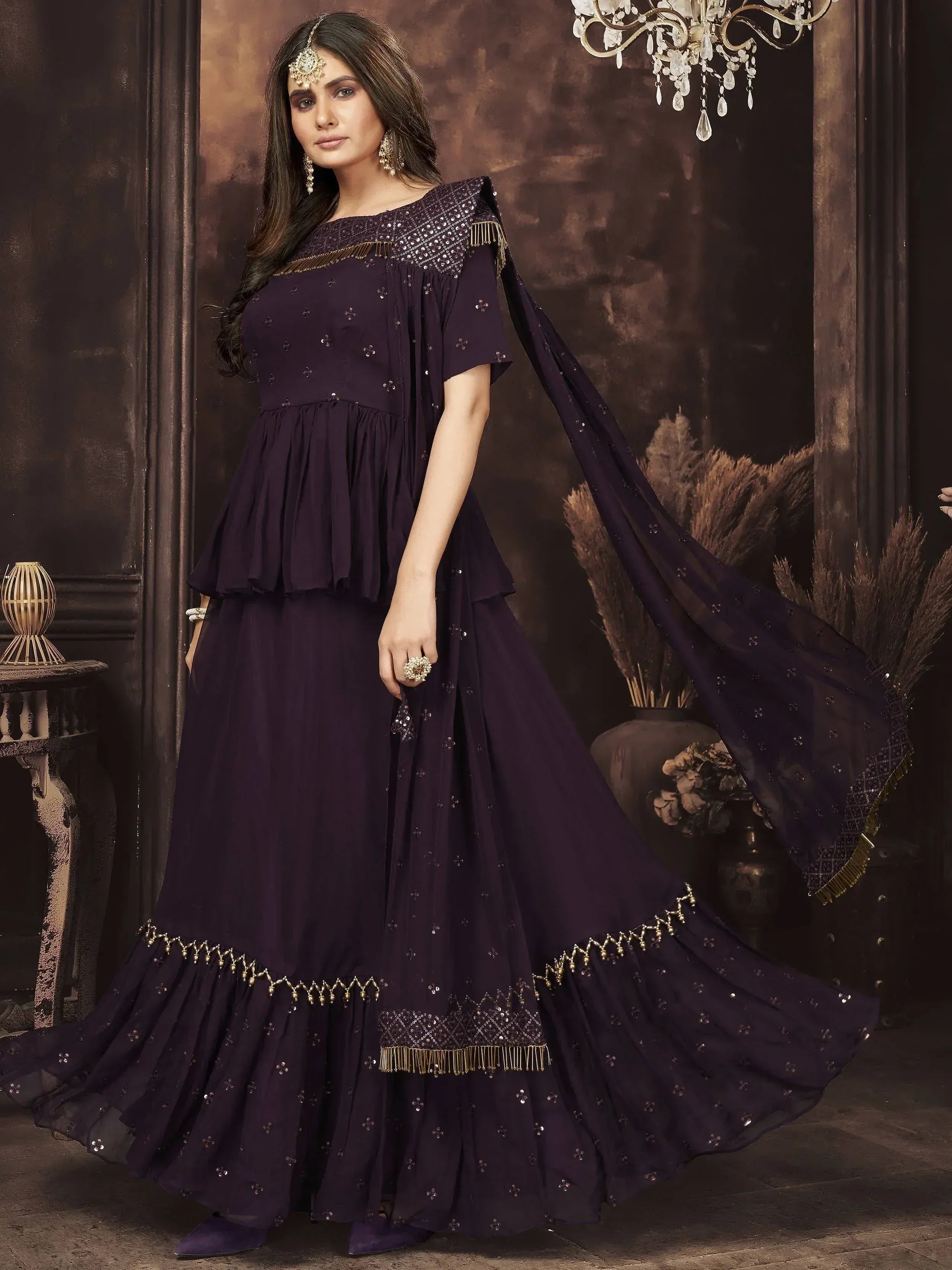 Elegant purple ethnic gown with sequin embroidery and gold fringe, perfect for Indian festive occasions
