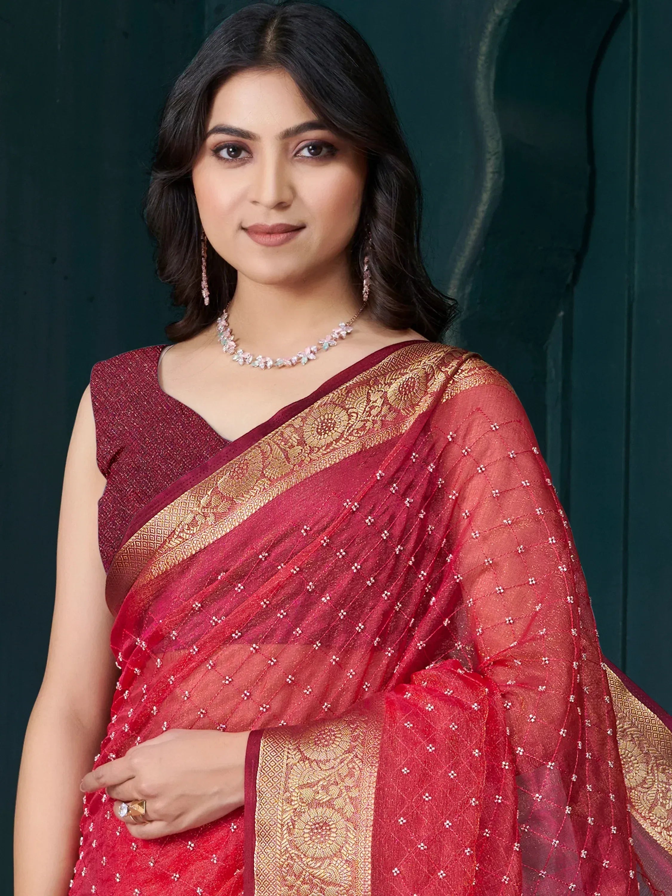 Elegant red saree with golden border and embellishments, perfect for Indian ethnic wear