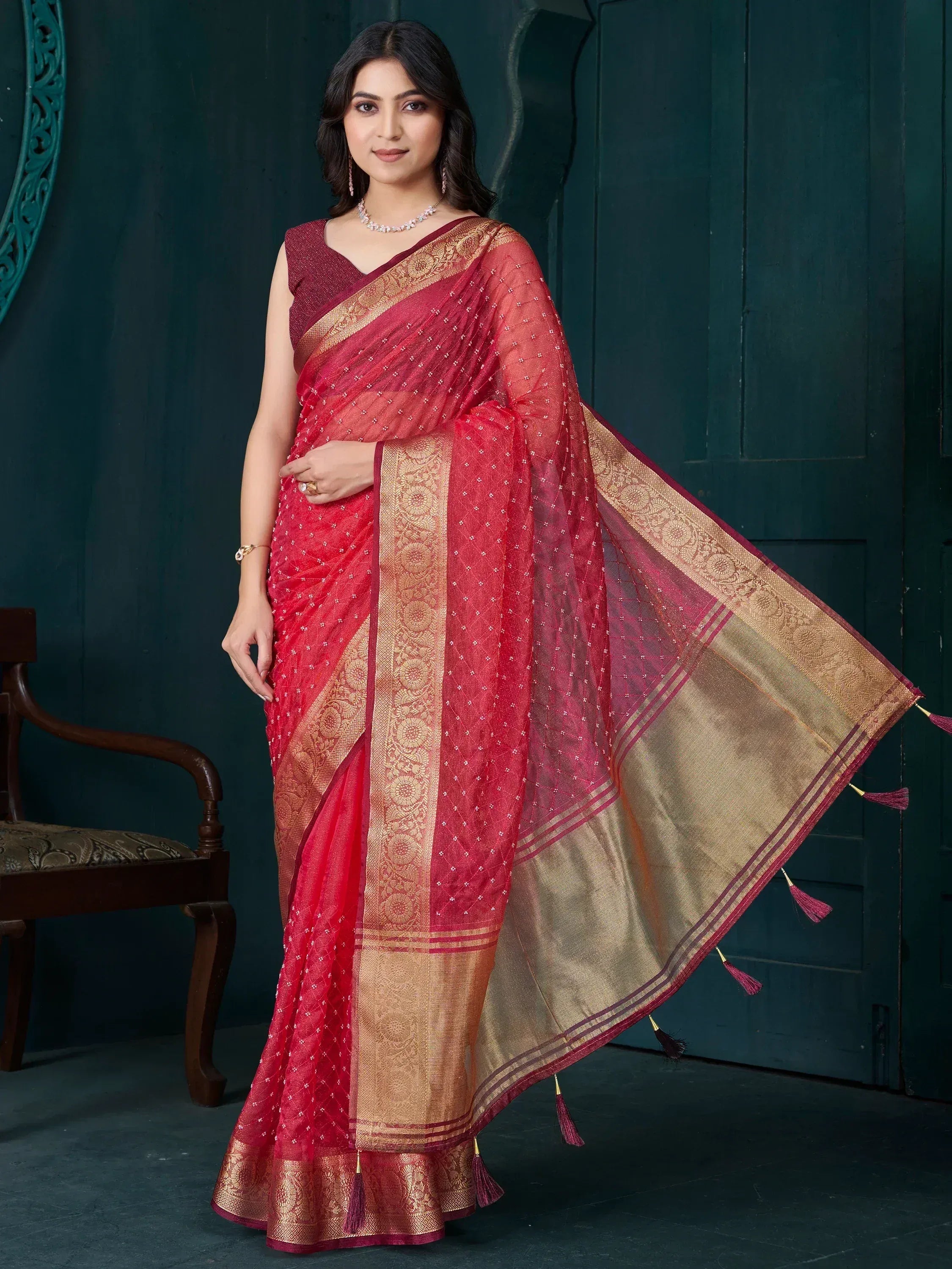 Red and gold embroidered saree with tassels, perfect for Indian ethnic occasions
