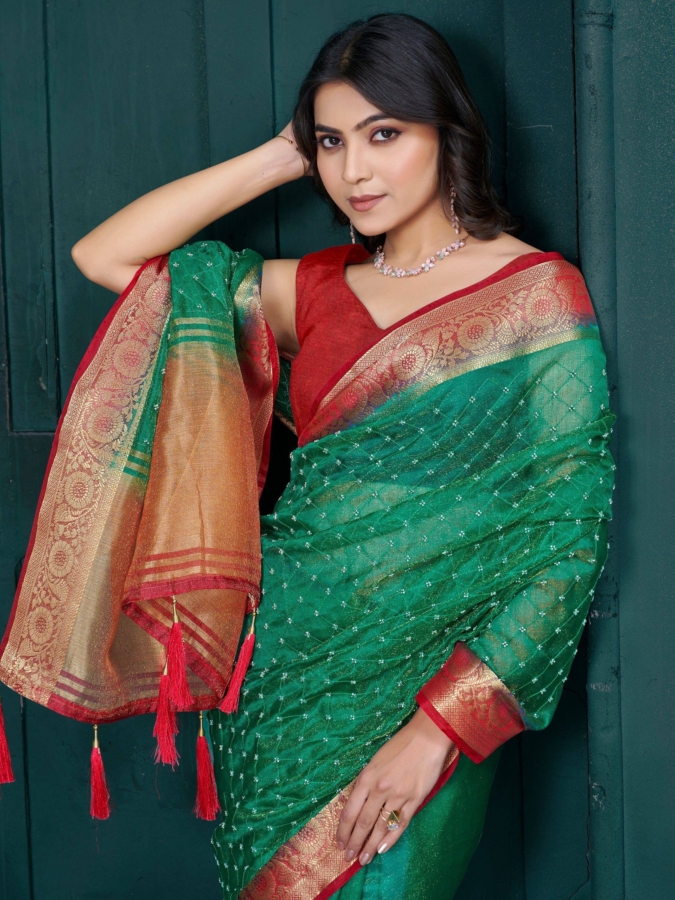 Green and red designer saree with golden border and tassels, perfect for ethnic occasions