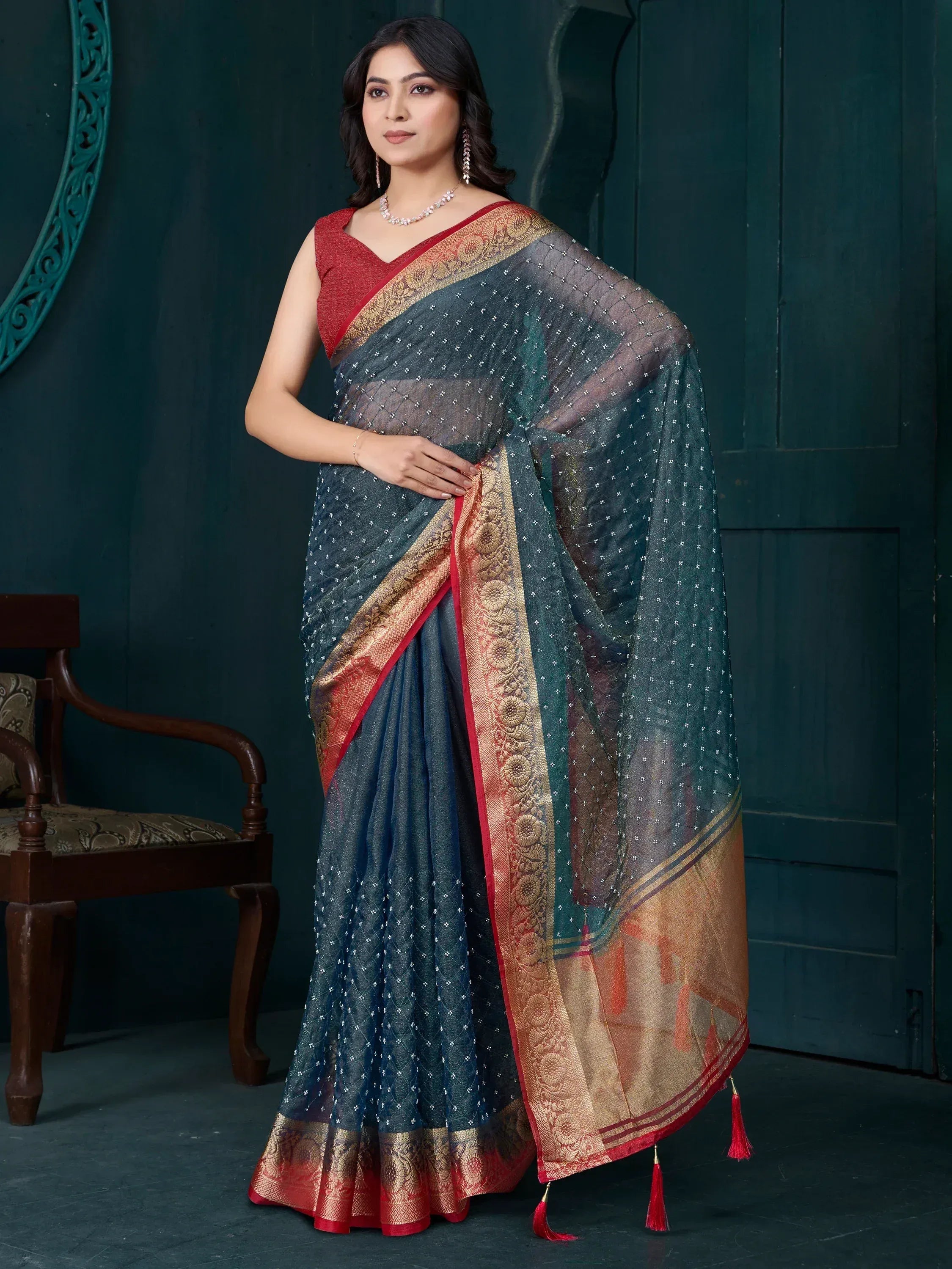 Elegant dark blue saree with gold and red border, perfect for Indian ethnic wear occasions