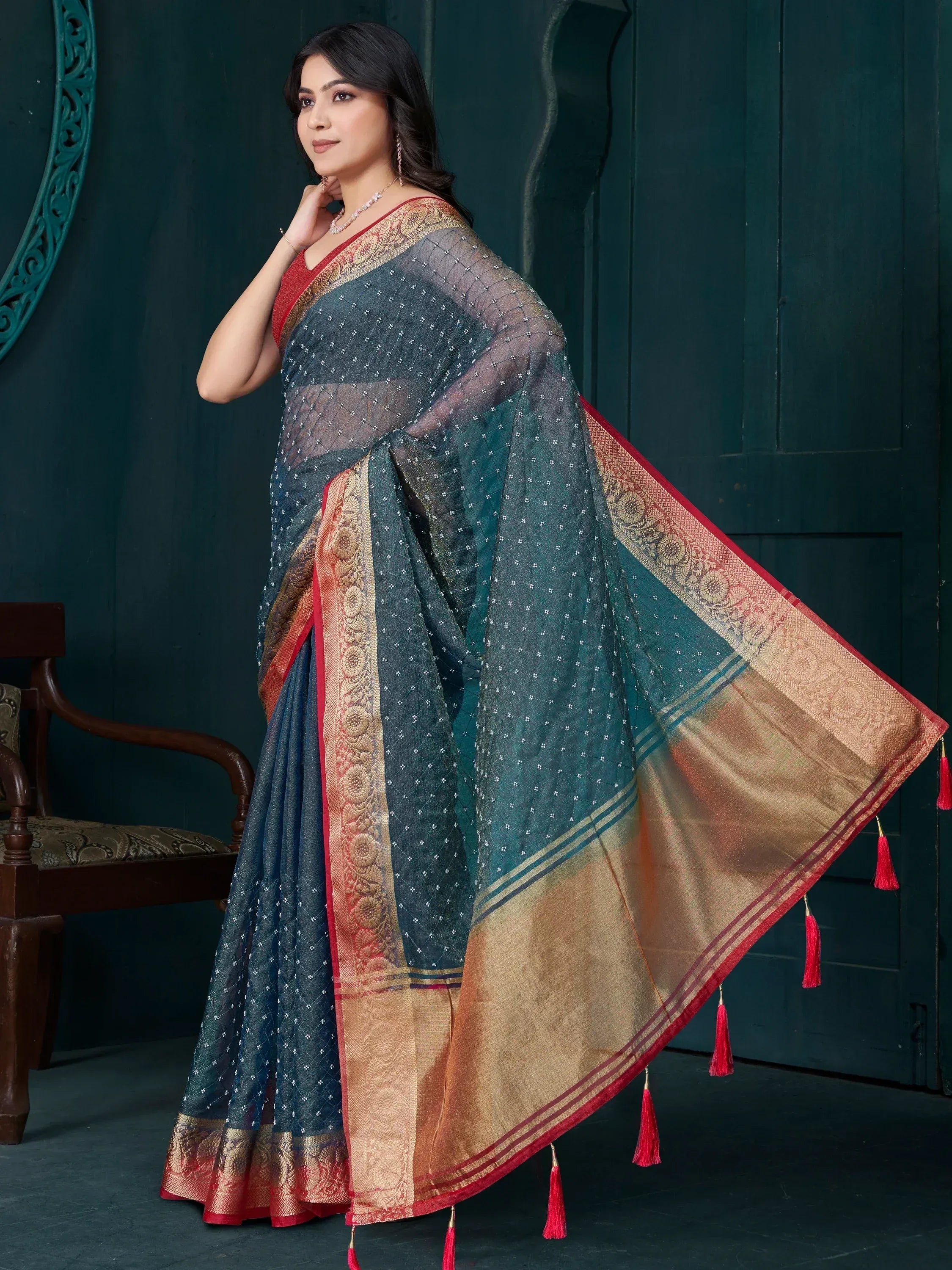 Elegant teal saree with gold border and red tassels, perfect for Indian ethnic wear