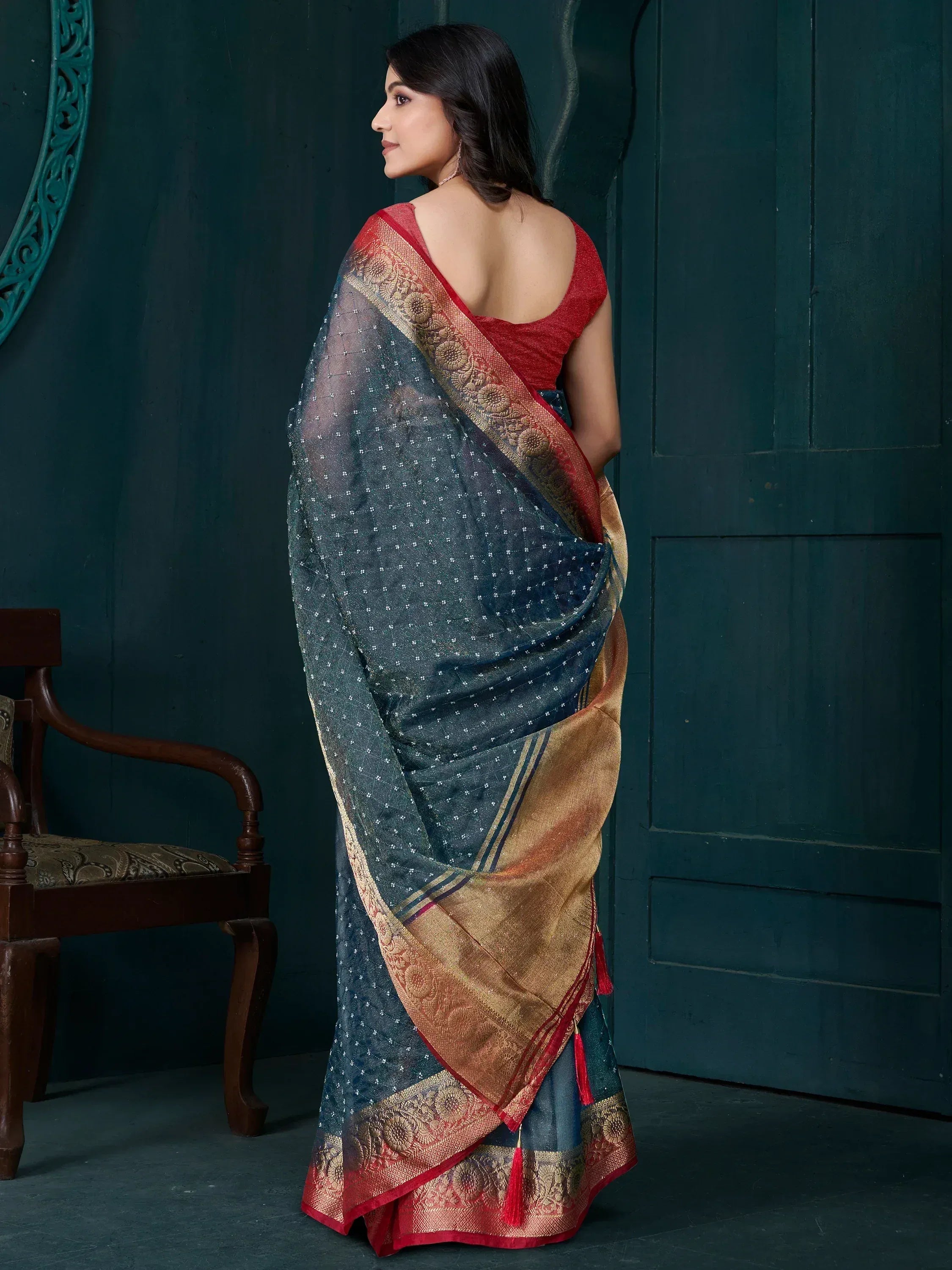 Elegant blue saree with gold border and red blouse, perfect for Indian ethnic wear occasions.