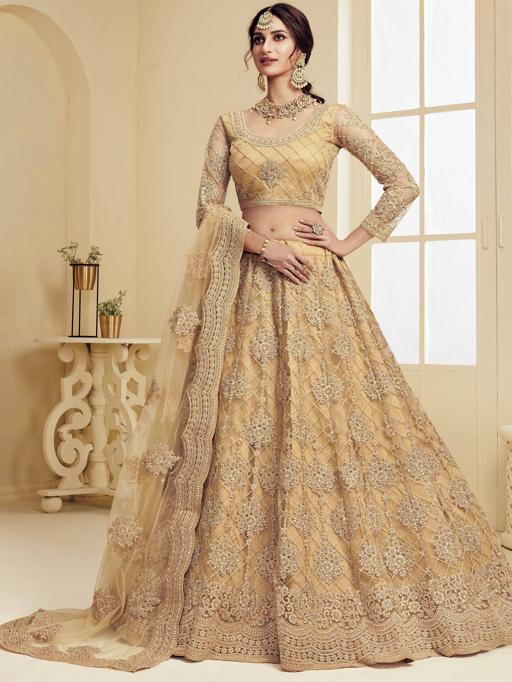 Gold embroidered lehenga choli with net dupatta, perfect for Indian weddings and festive occasions.