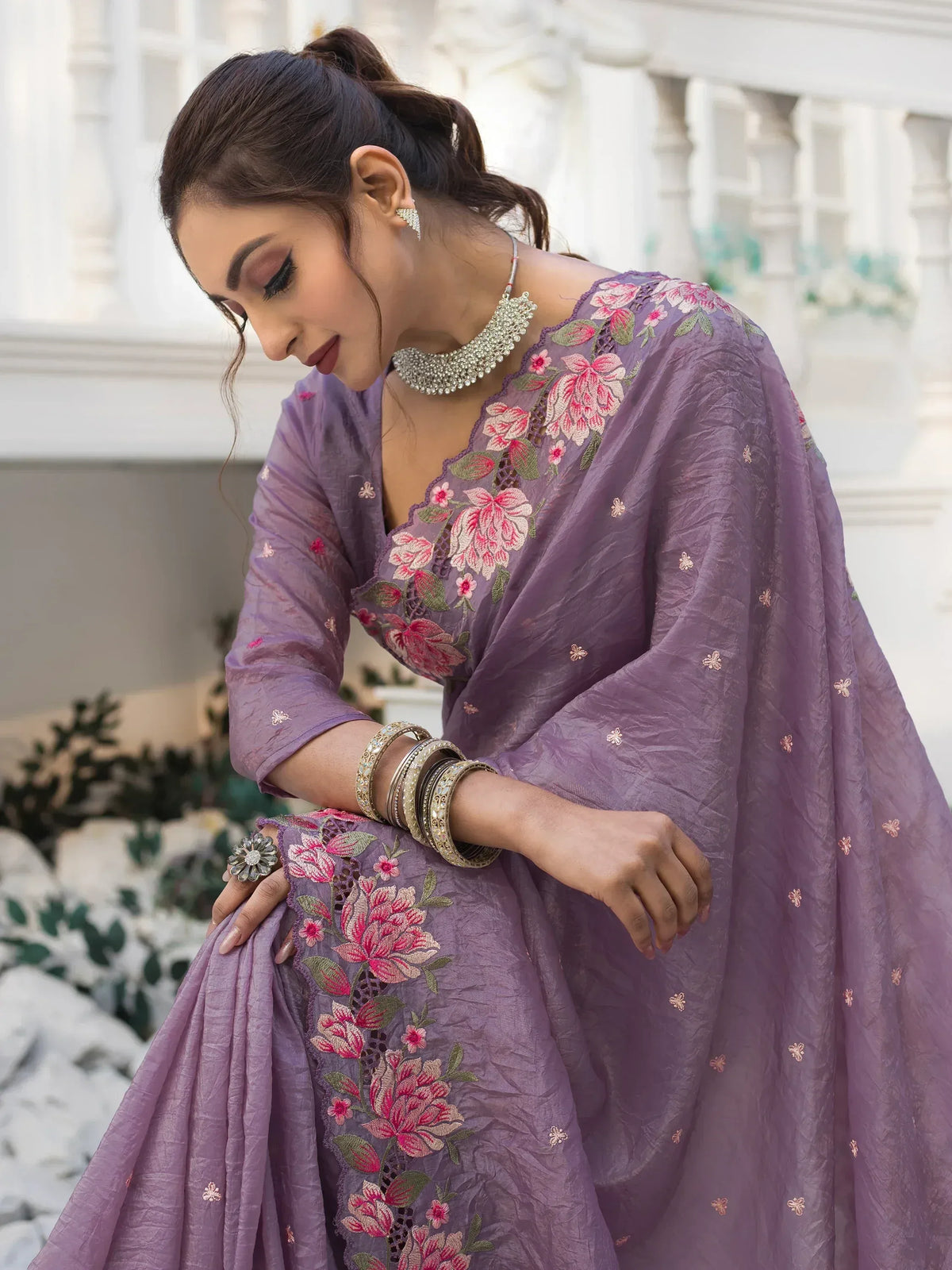 Purple floral embroidered Indian ethnic gown with designer neckline and traditional jewelry