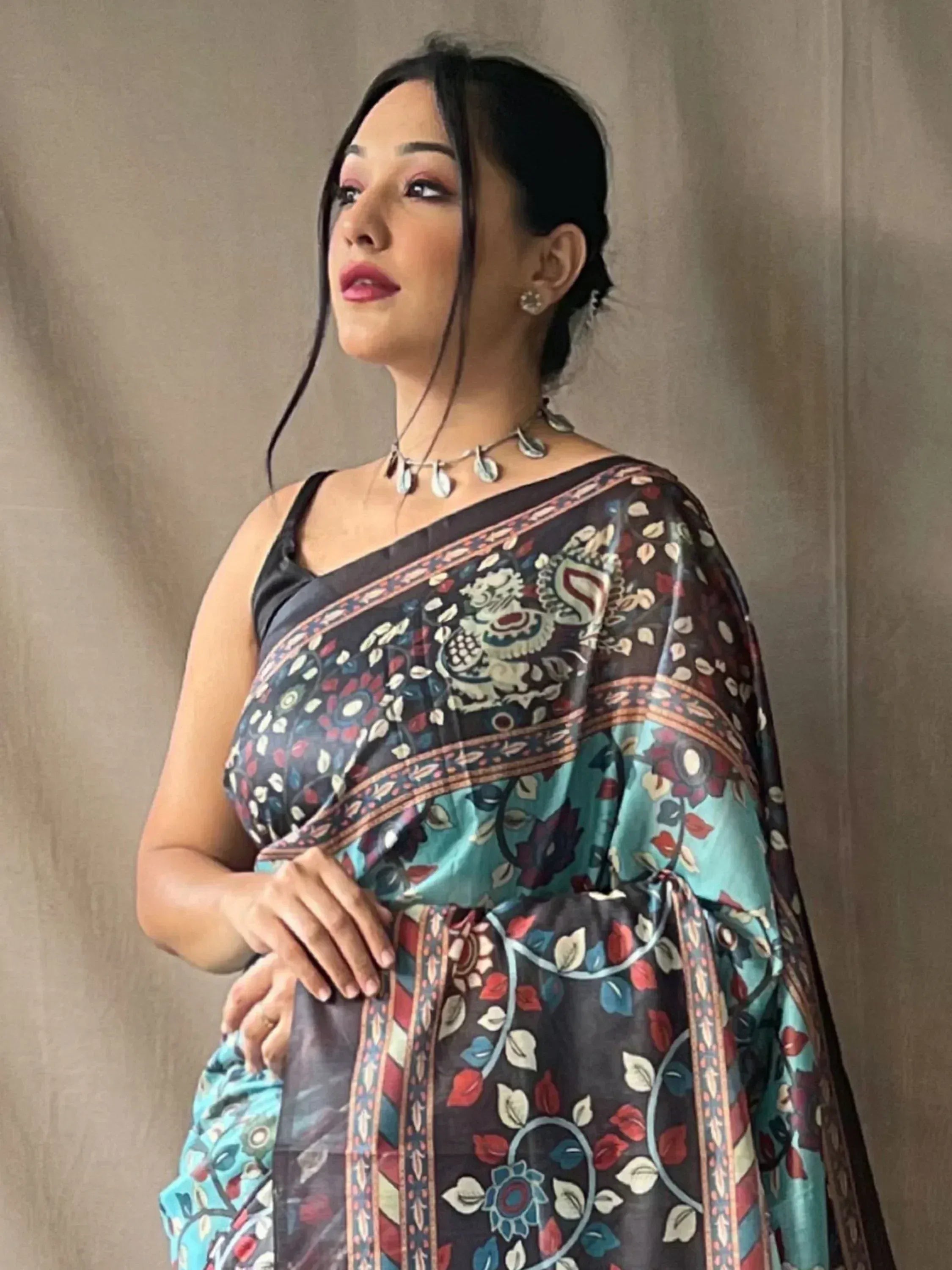 Woman in floral printed ethnic saree with black blouse, perfect for Indian occasions