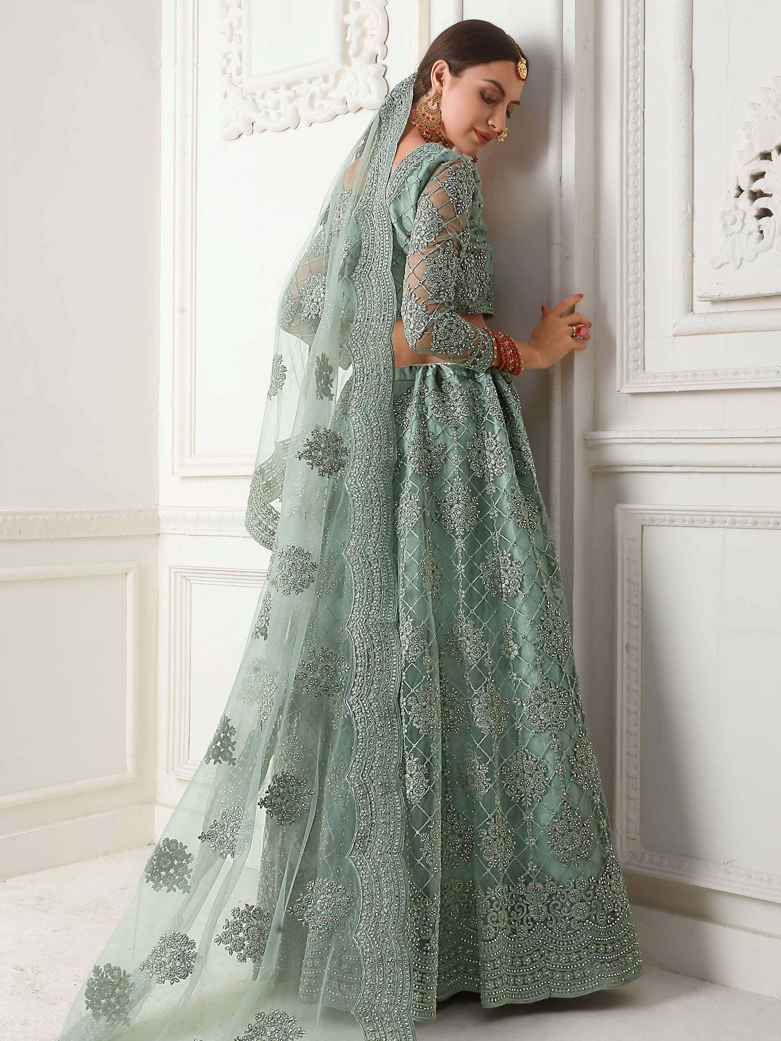 Mint green designer lehenga choli with heavy silver embroidery and sheer dupatta for weddings