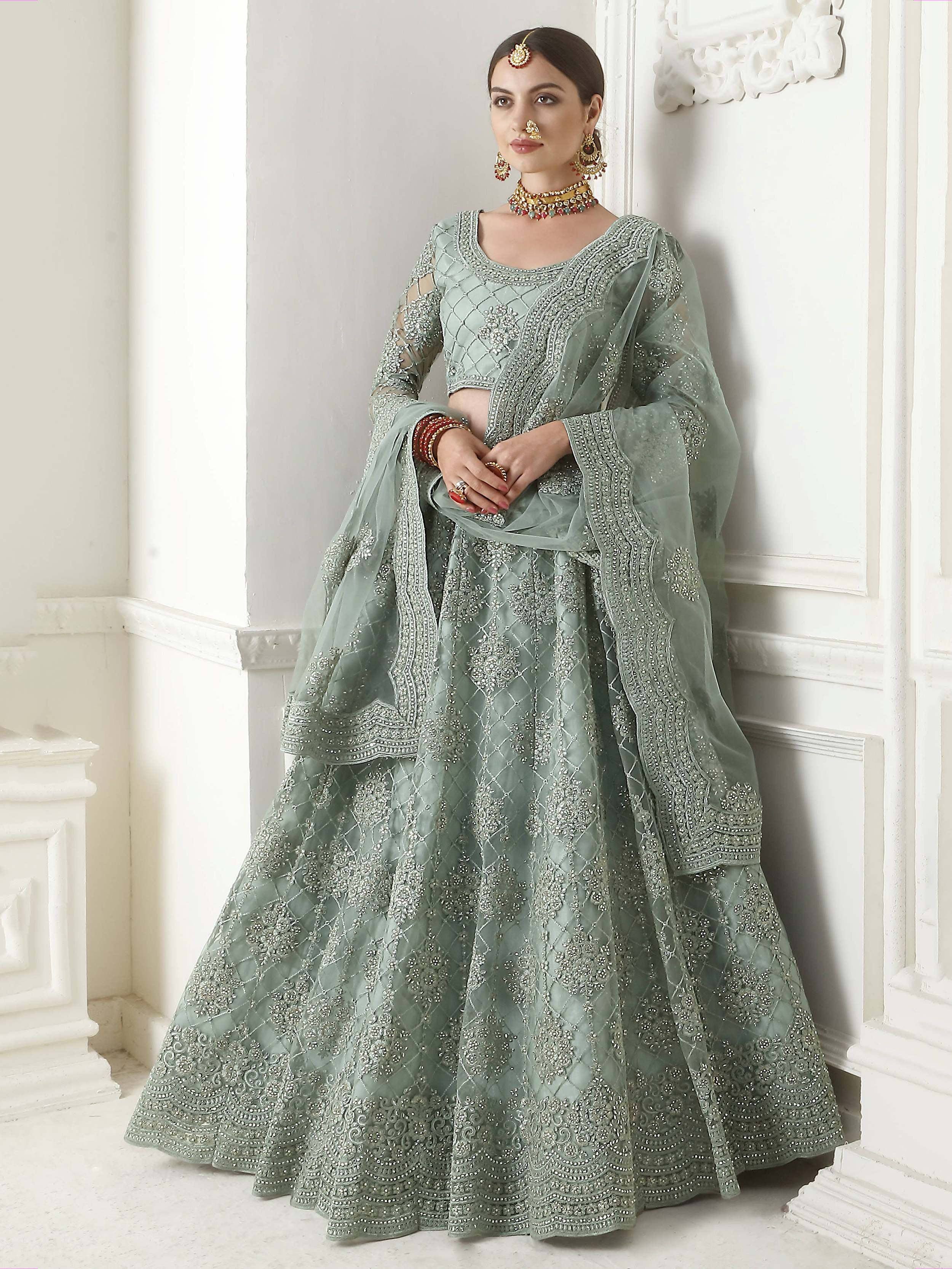 Elegant sage green designer lehenga choli with intricate embroidery and sheer dupatta for Indian ethnic wear