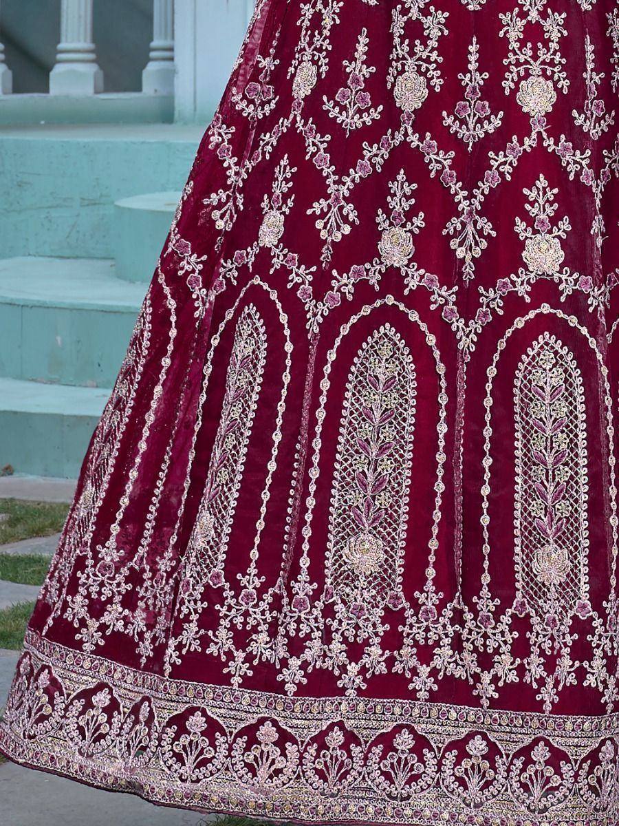 Maroon velvet lehenga with intricate gold and pink floral embroidery, perfect for Indian weddings