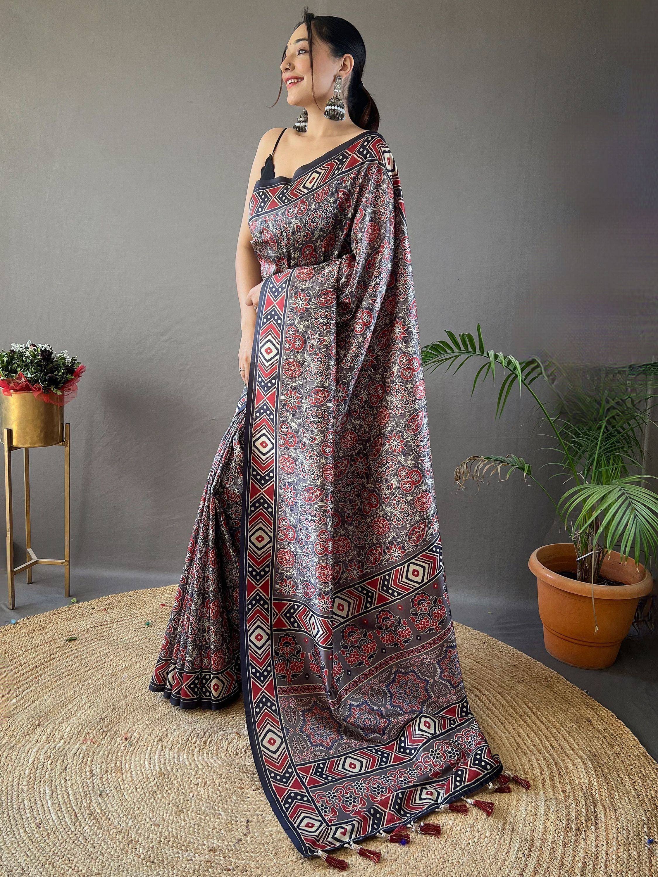 Woman in printed ethnic saree with geometric border, perfect for Indian occasions and festivals.