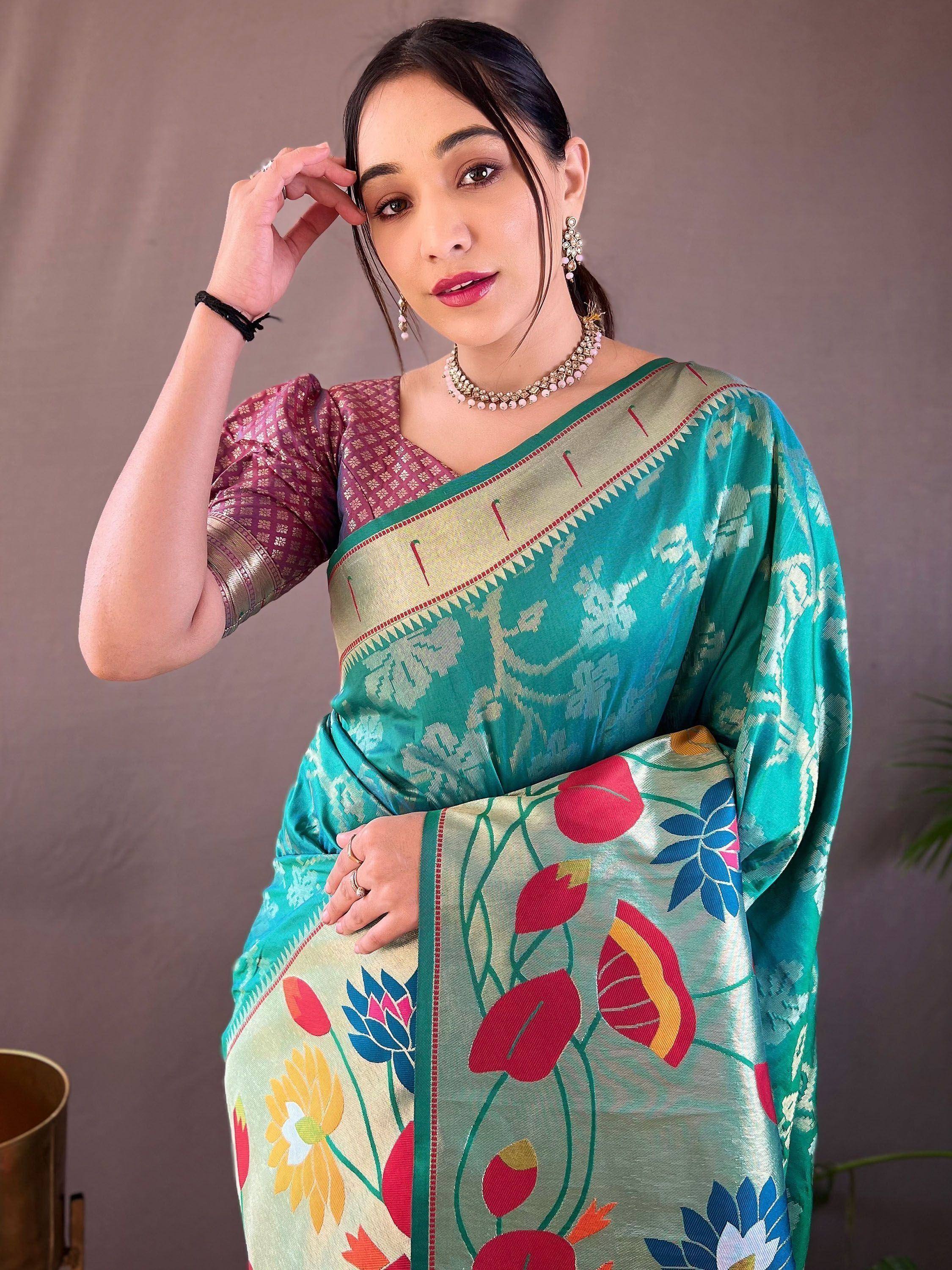 Woman in vibrant teal floral saree with contrasting blouse, traditional Indian ethnic wear