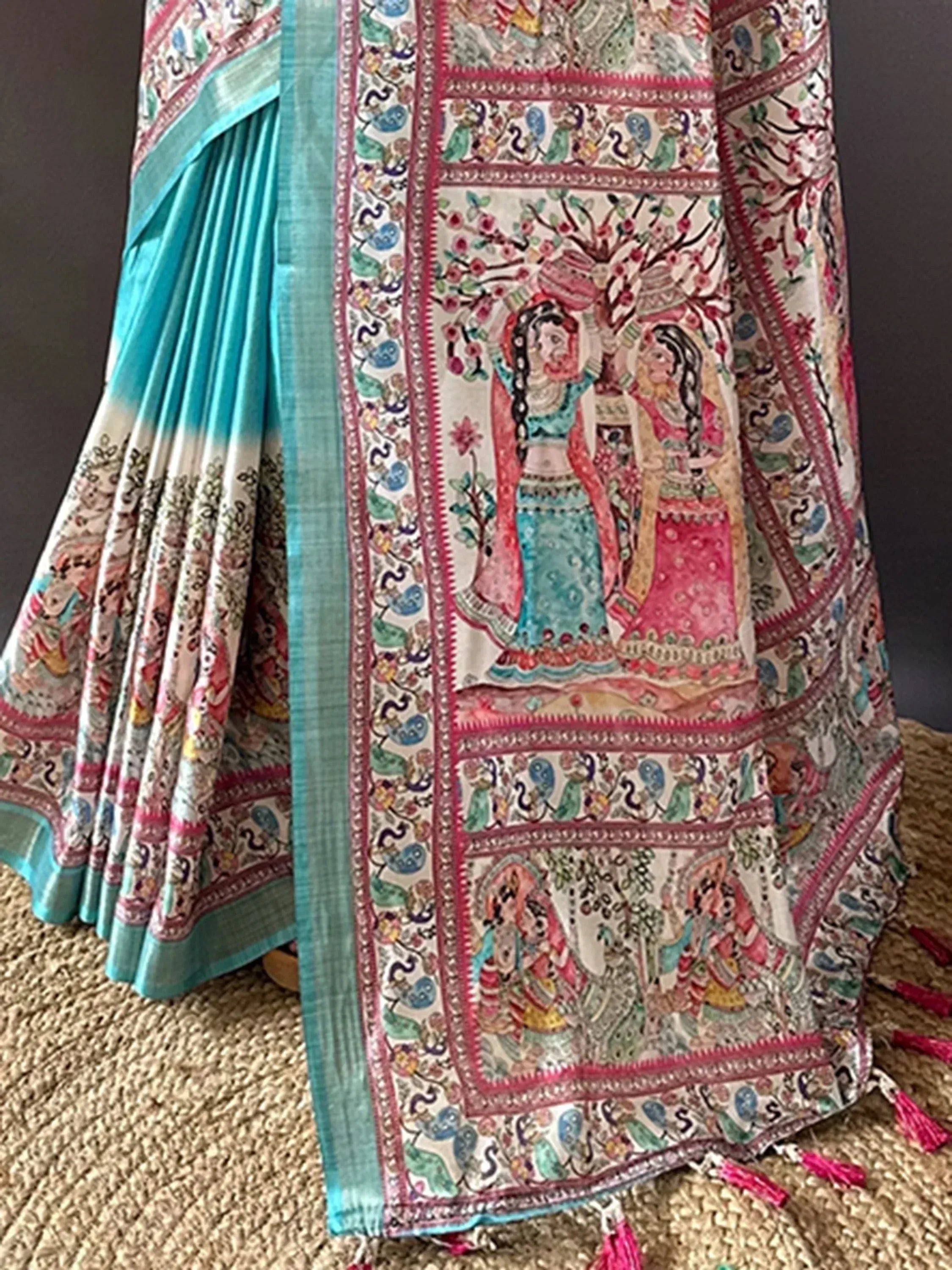 Turquoise and cream saree with intricate hand-painted folk art, floral motifs, and tassels for ethnic wear