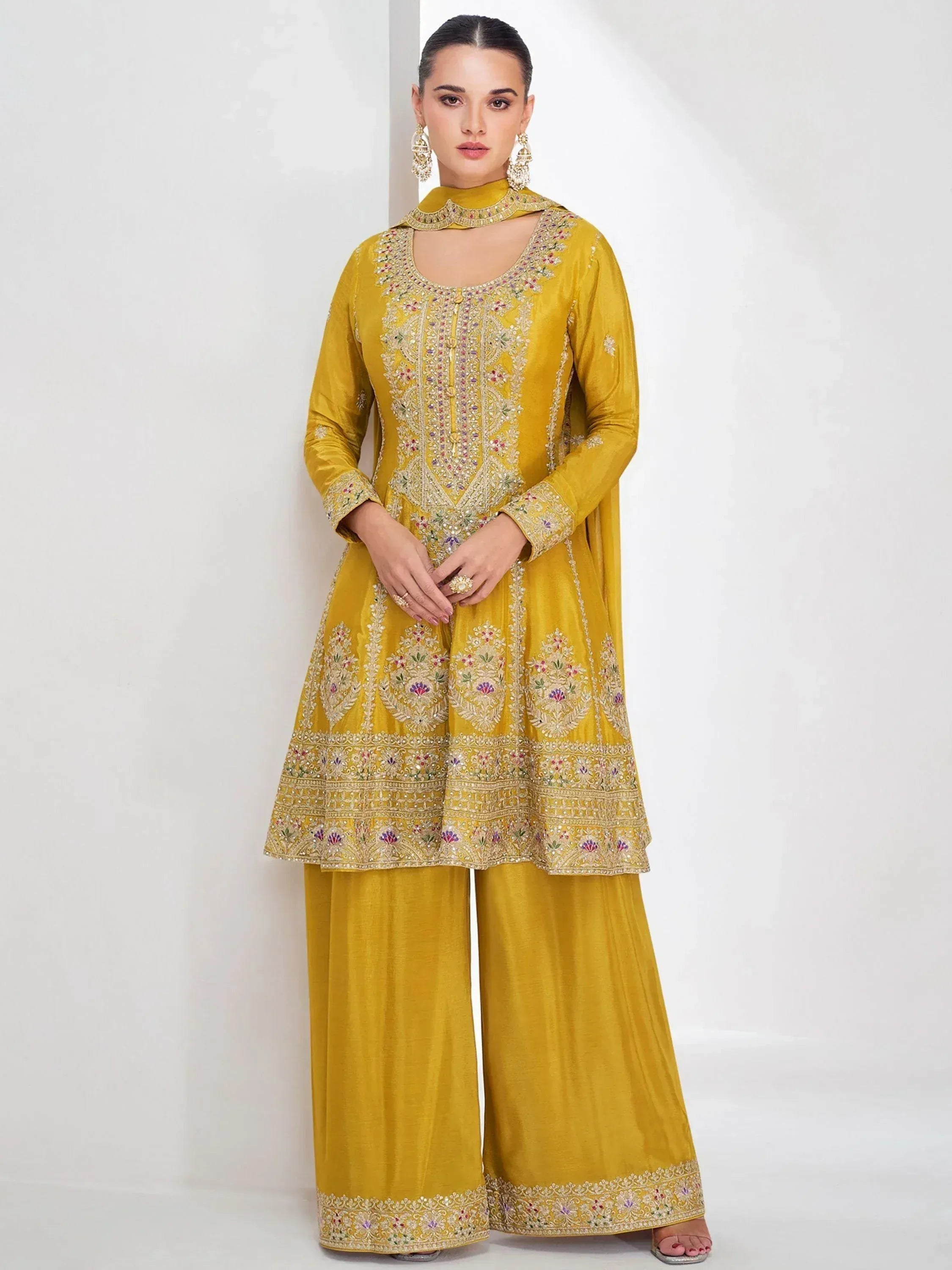 Yellow embroidered Indian salwar kameez with floral motifs and matching palazzo pants