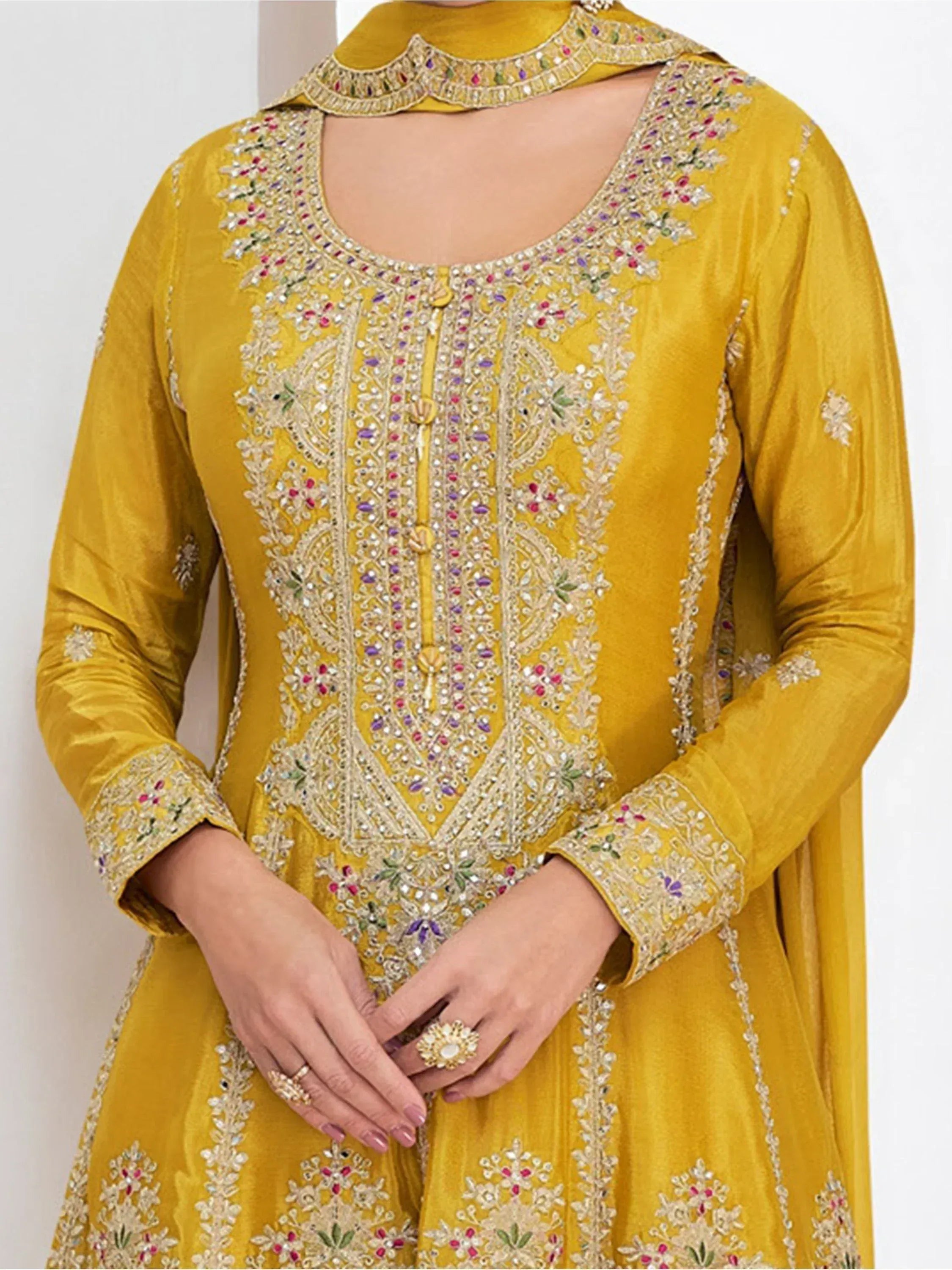 Mustard yellow ethnic anarkali with intricate floral embroidery and mirror work, perfect for festive occasions.