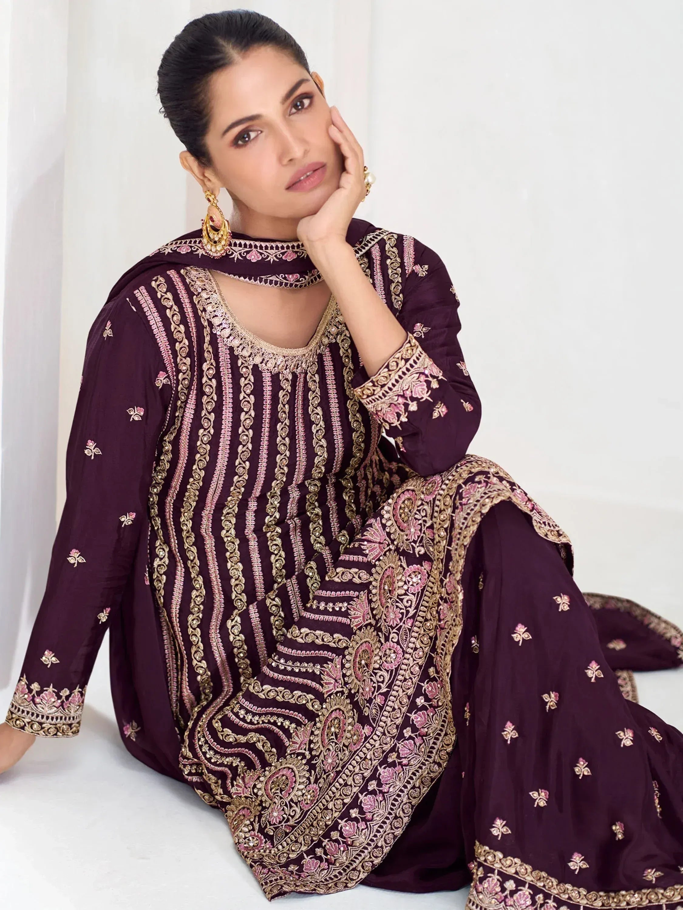 Elegant purple embroidered salwar kameez with gold and pink detailing, perfect for festive occasions.