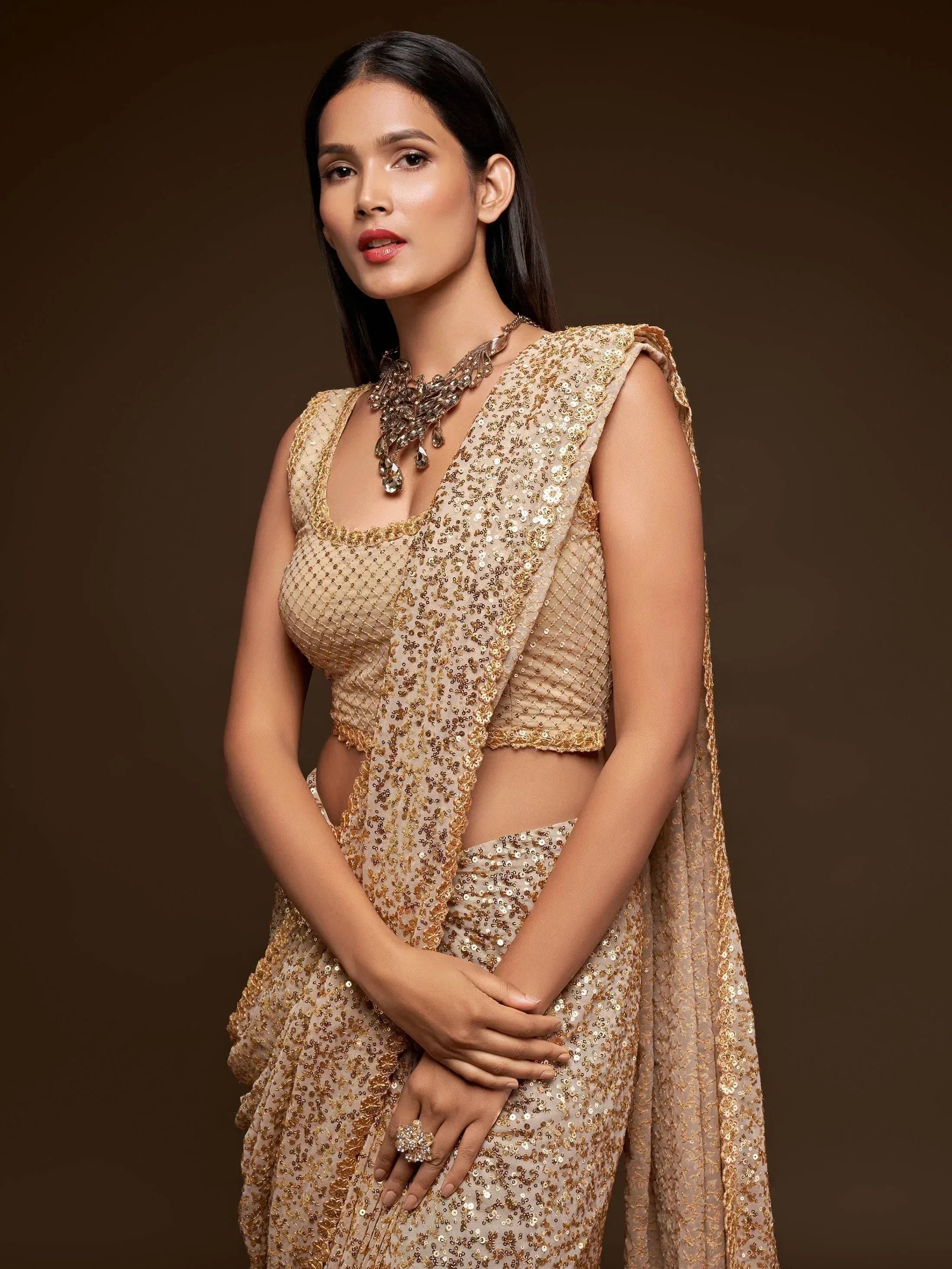 Golden sequin lehenga choli with cape, perfect for Indian ethnic wear and festive occasions.