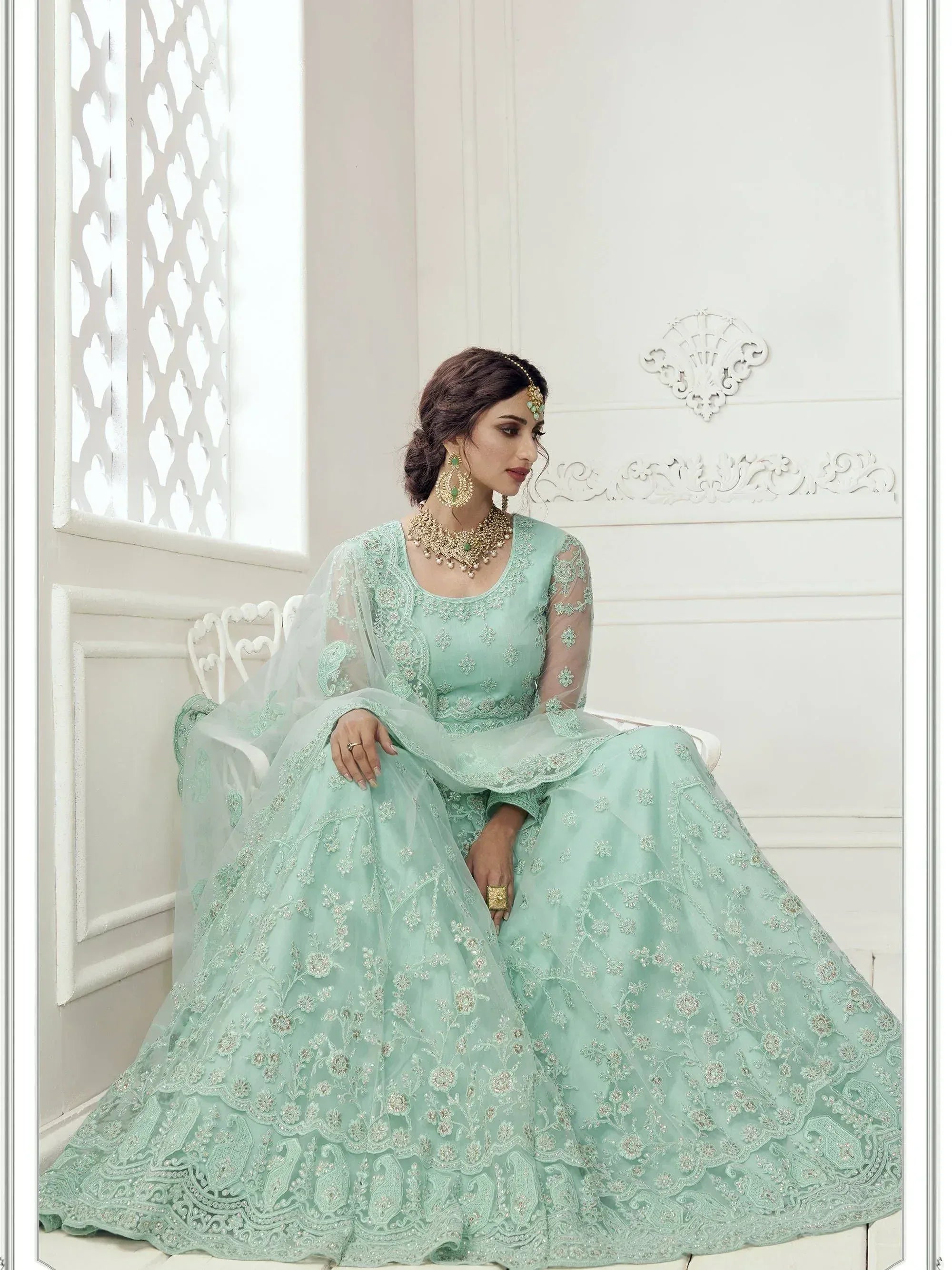 Mint green designer lehenga choli with floral embroidery, perfect for Indian weddings and festive occasions.