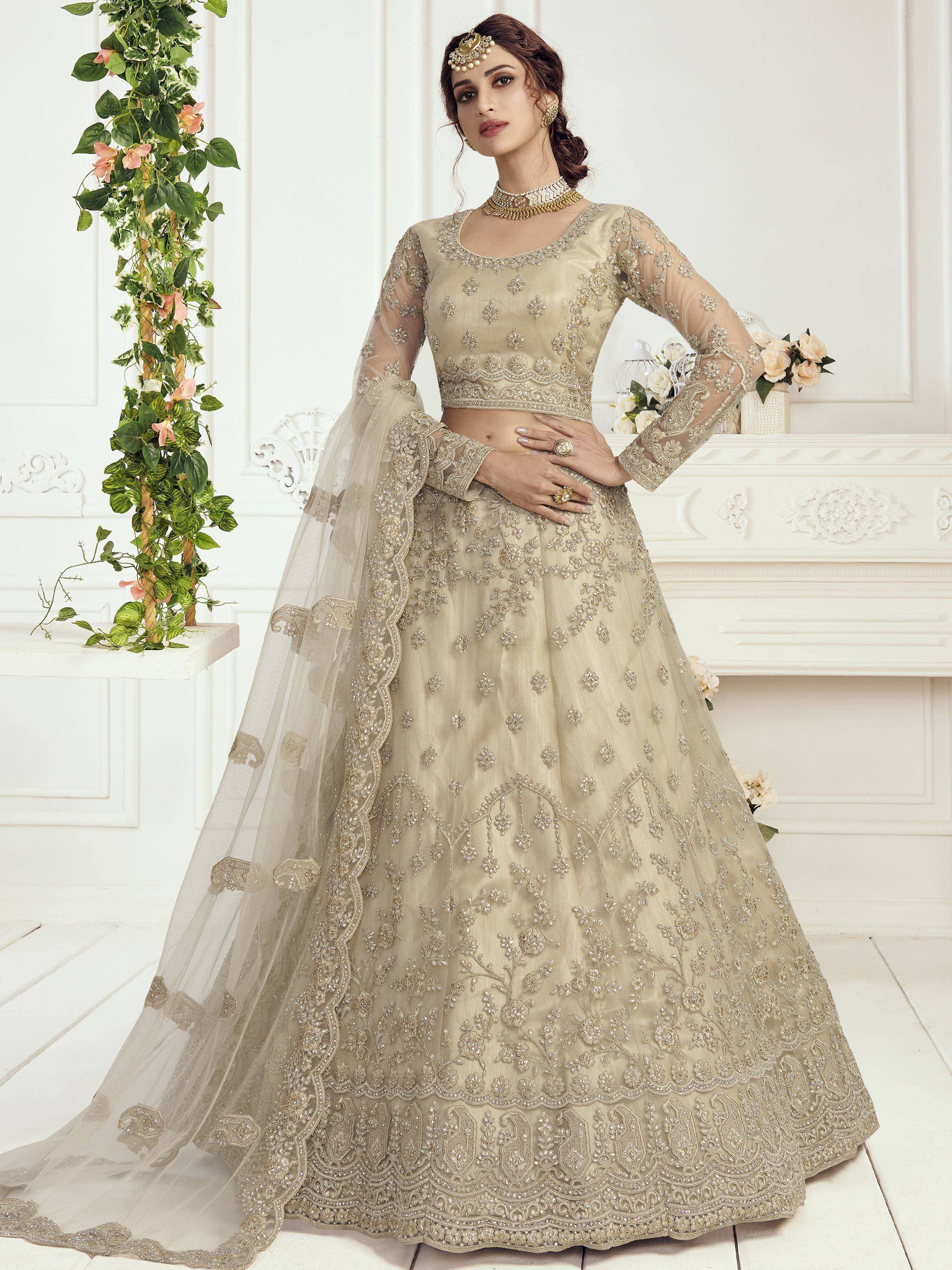 Beige embroidered lehenga choli with sheer sleeves and floral detailing, perfect for Indian weddings