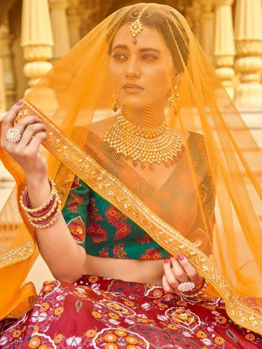 Indian bride in floral lehenga choli with golden dupatta and traditional jewelry